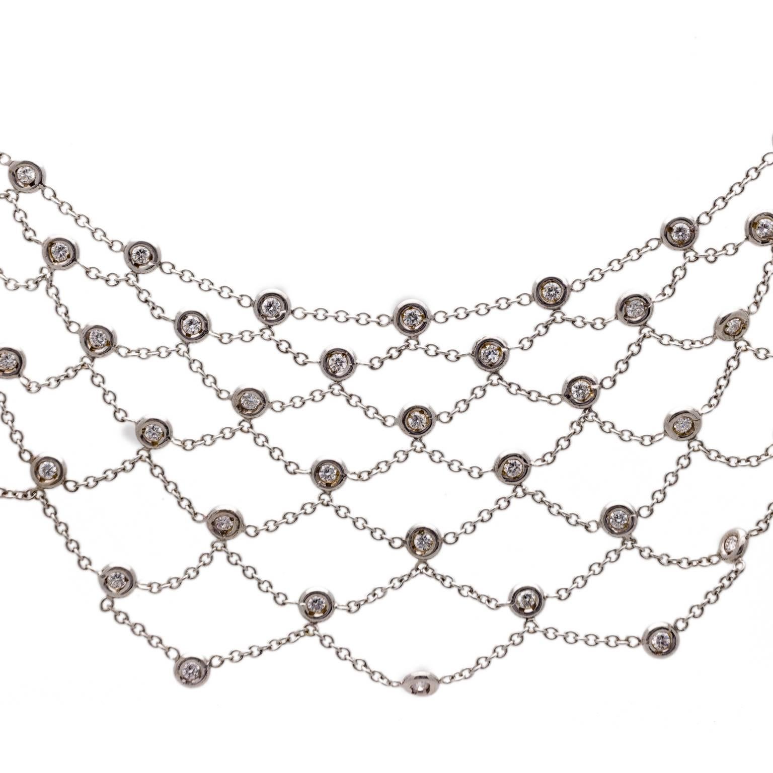 This diamond web necklace is sprinkled with a multitude of diamonds too numerous to count totaling almost 10 cts. Each stone is approximately 0.050 cts to interlock each web strand in 18k white gold. This necklace beautifully drapes on your neck for