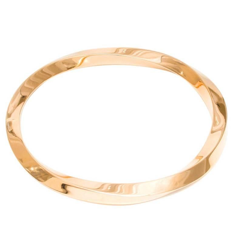 1930's Classic Tiffany & Co 18k yellow gold slip on twisted bangle bracelet. Fits a standard 7 to 7 1/2 inch wrist. 

Round shape inside diameter: 2 1/4 inches
Width: 6.5mm
Height: 6.2mm
Stamped: Tiffany + Co 18k Italy
33.9 grams

Please Note, we