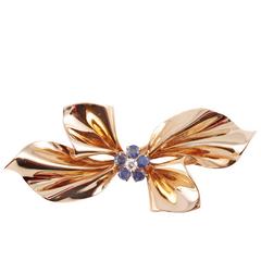 14 karat yellow gold, blue sapphire and diamond brooch