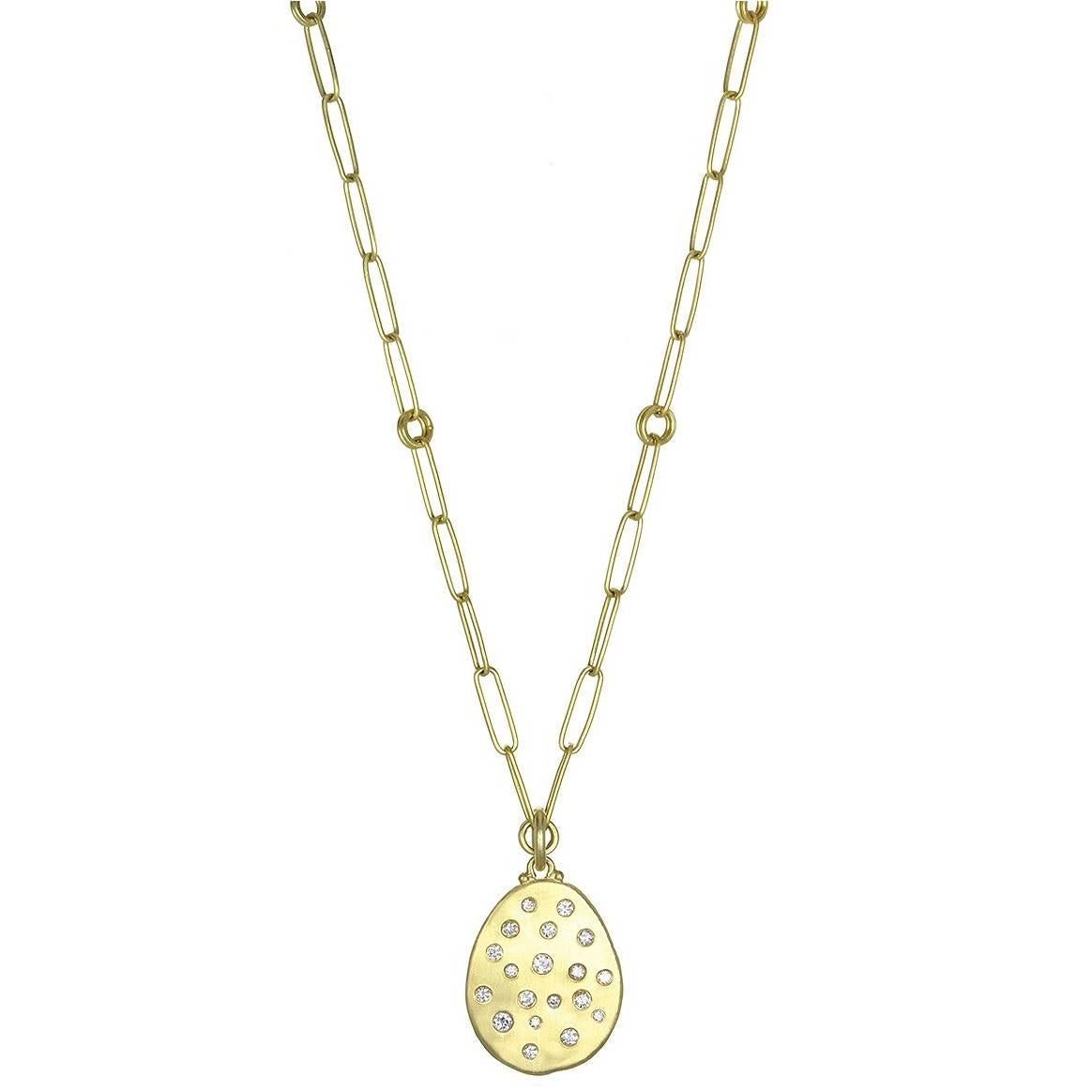 The dog tag pendant has been given a sophisticated twist.  Displayed on a paperclip chain, the 18K gold diamond dog tag pendant is one of Faye Kim's signature designs.  Layer with shorter necklaces or wear on a leather cord for 
a casual, chic