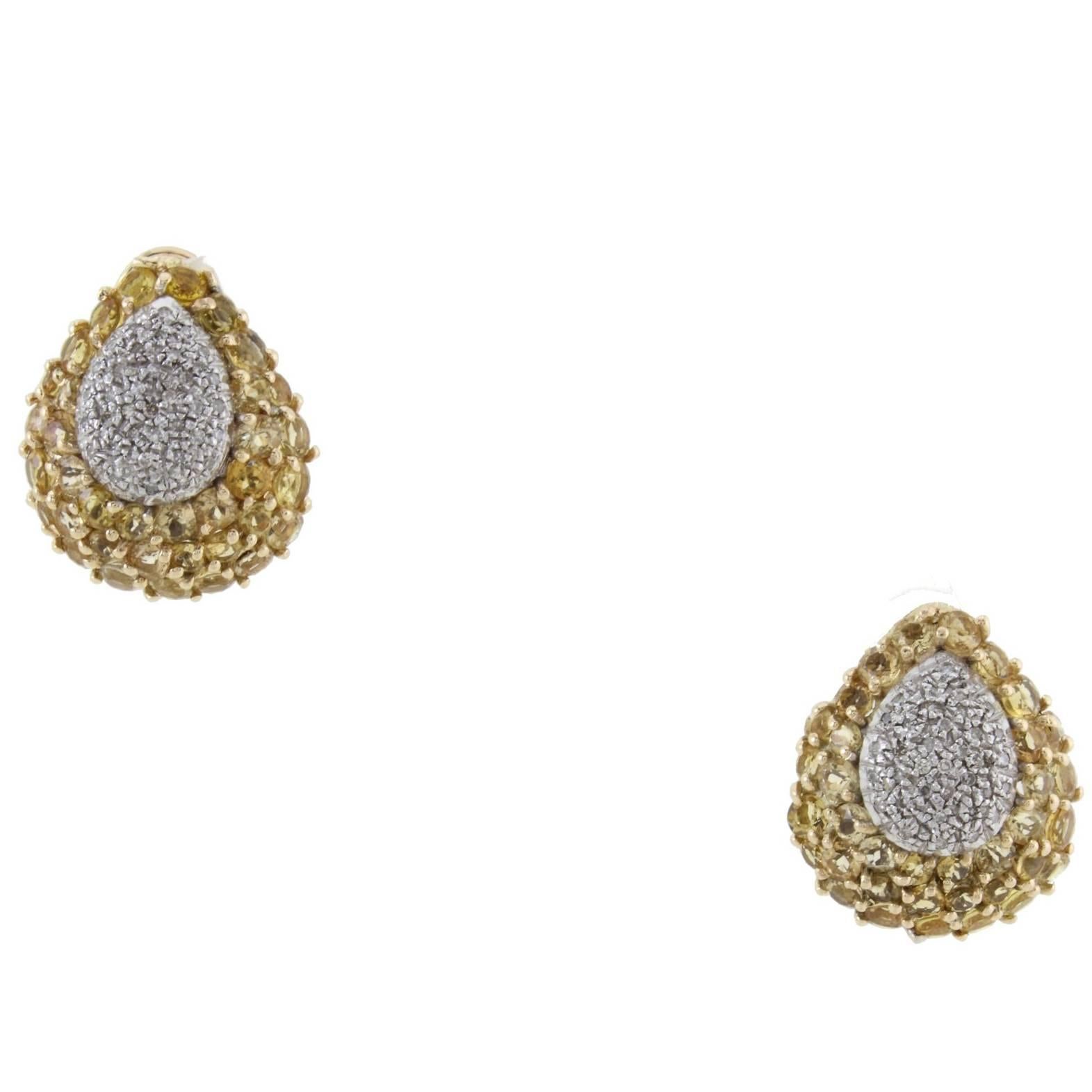 Clip-on earrings in 14k yellow and white gold mounted with 2 diamonds drops and 2 yellow topaz drops.
Diamonds 0.62 kt
Topaz 8.30 kt 
Tot.Weight 19.00 gr
R.F ufei 
