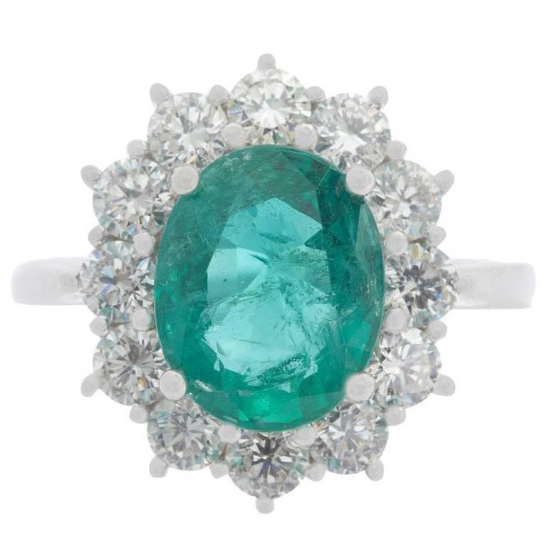 18 Carat White Gold 2.68 Carat Emerald and 1.29 Carat Diamond Cluster Ring For Sale