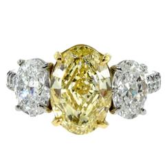 Oval Diamond Three-Stone Engagement Ring with Fancy Yellow Center in Platinum