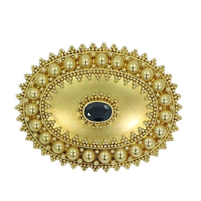 Oval Sapphire Yellow Gold Pin For Sale