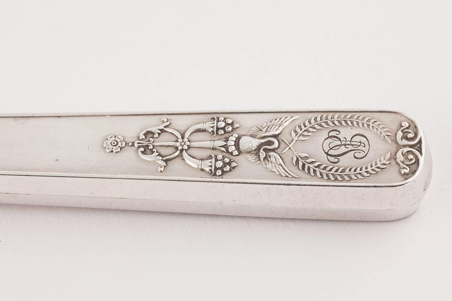 This attractive silver engraved fish service pair is from Fabergé's Moscow workshop at the turn-of-the-century. In the neoclassical taste, the handles are decorated with splayed swans, wreathes and cornucopiae, the fork and knife are engraved with