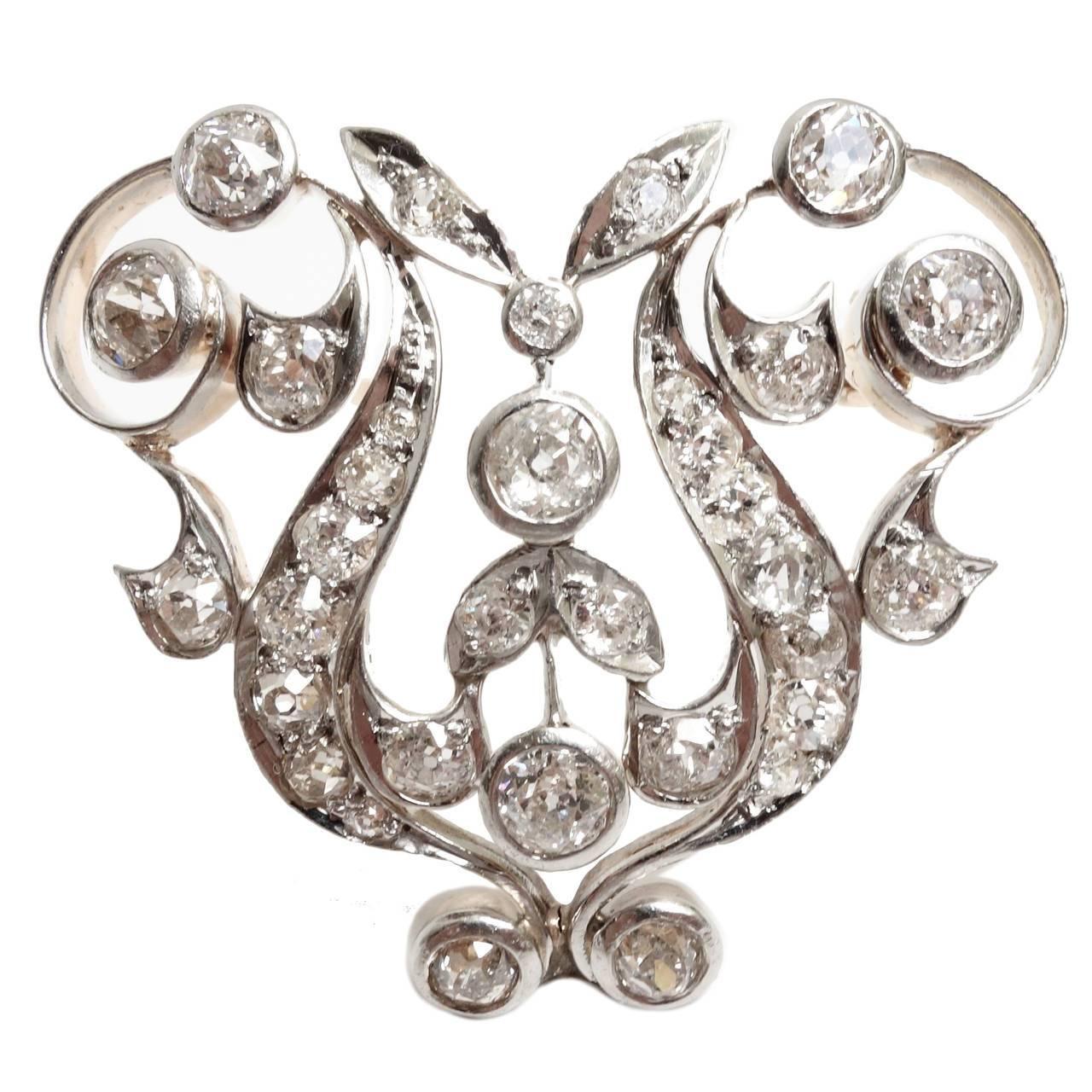 Belle Epoque  diamond brooch conversion with a sweeping floral and foliate motif, crafted in Platinum and 14K yellow gold, supported by an 18K yellow gold rolo style chain. Fully set with old mine cut bead and bezel set diamonds, approximate total
