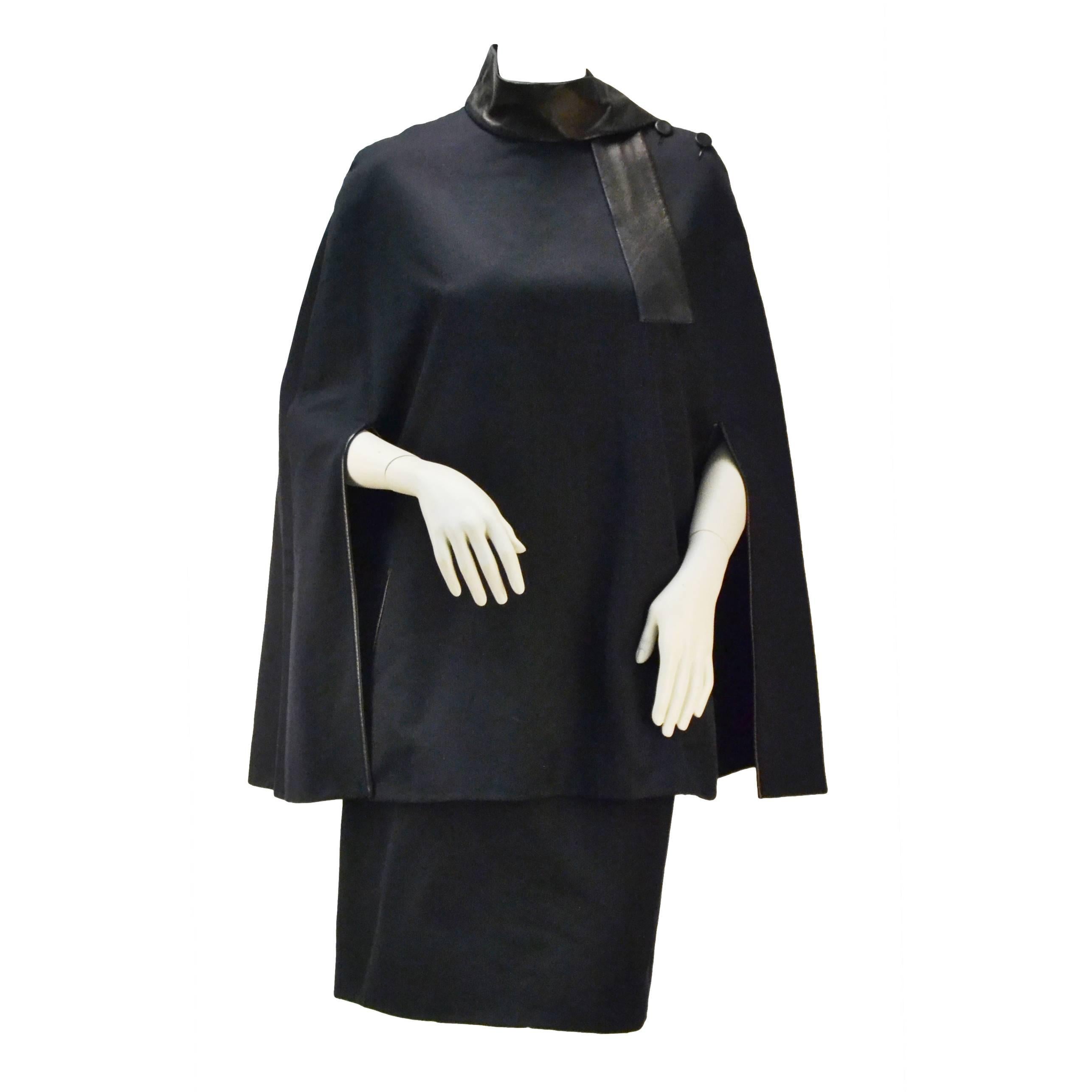 Fabulous statement cape ensemble proves Galliano's talent when he took over the helm of the coveted fashion house as its founder retired.  A Must have for any wardrobe!

This navy cape with a leather collar along the neck give a gal an image of