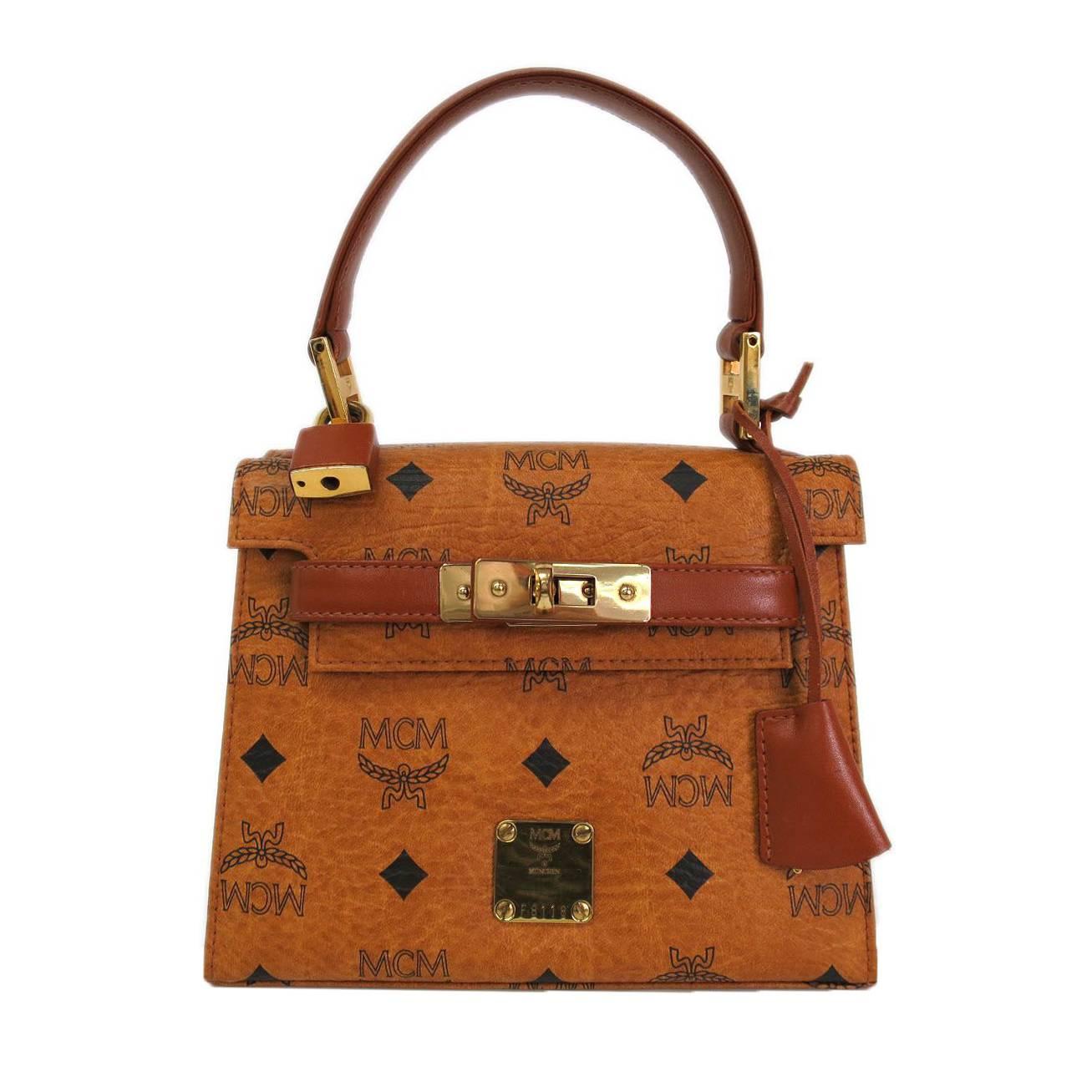 MCM Cognac Braun Monogrammierte Kelly Top Handle Satchel Tasche mit Goldbeschlägen