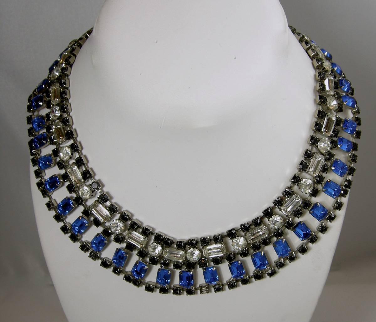 This vintage 1950s royal blue, clear, and black rhinestone choker necklace is the perfect piece of jewelry for a night on the town. It has round black stones that encircle the neck, with larger rectangular blue and clear stones that alternate