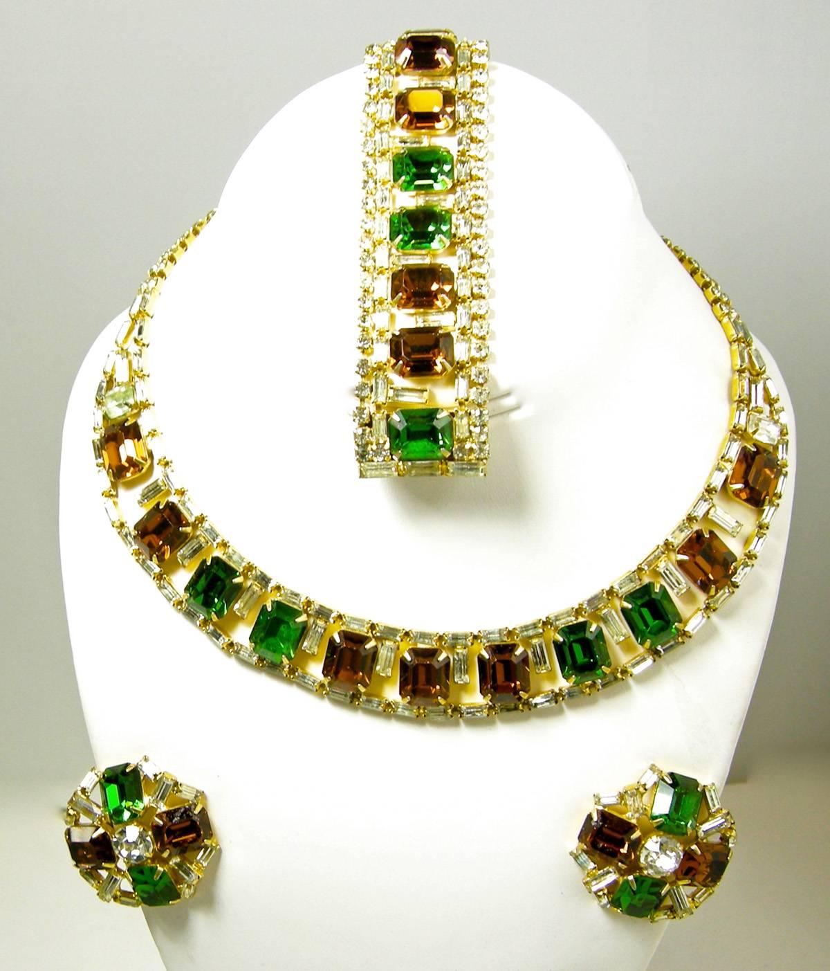 I was very happy to come across this vintage Hobe parure.  It is difficult to find this set complete with the bracelet, earrings and necklace.  This vintage Hobe set is designed with emerald green, topaz brown, and clear baguettes. The necklace