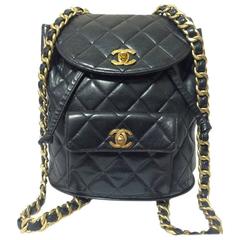 Vintage CHANEL quilted black lamb leather backpack with gold chain strap and CC