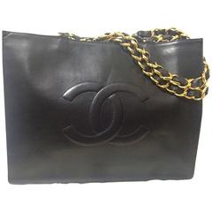 Vintage CHANEL black calfskin large tote bag with gold tone chain handles and CC