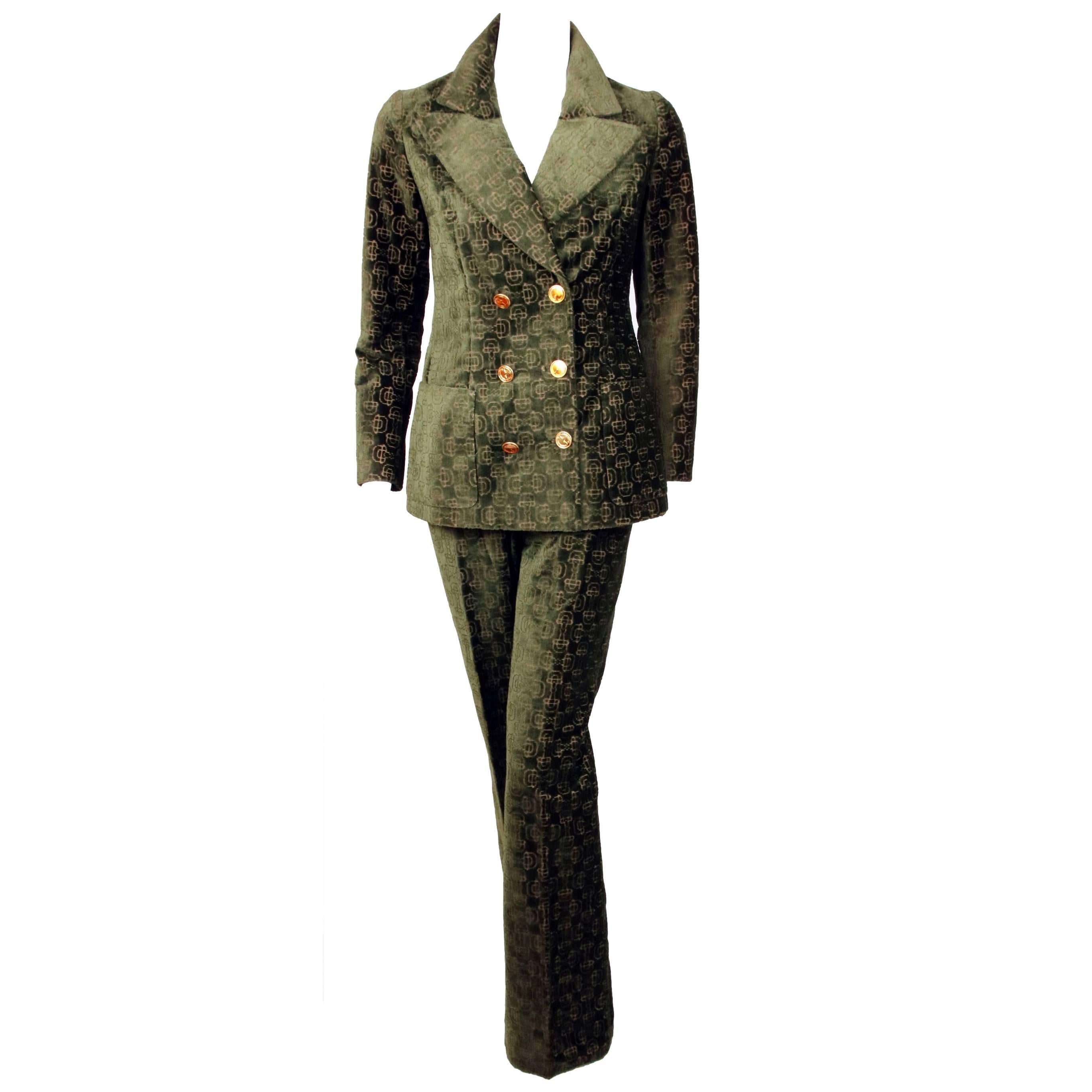 1970's Gucci cut velvet, horse bit print jacket and pant suit with Gucci logo buttons and enamel buckle attached to pants. In excellent condition. The glaze is cracked or missing on several of the buttons on the sleeve cuffs. Pants labeled a vintage