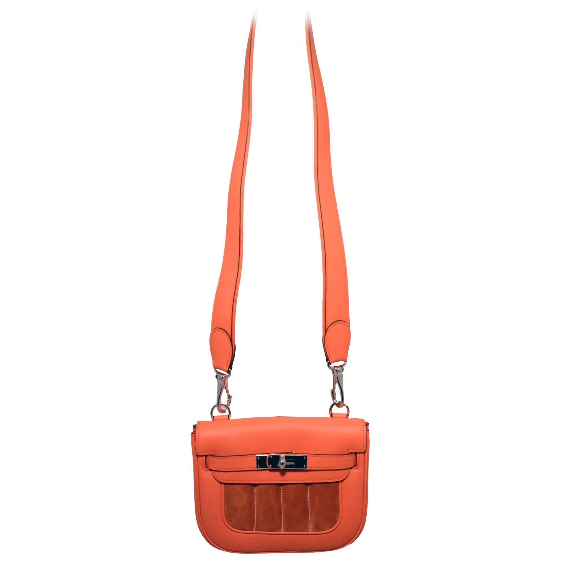 STUNNING Hermes berline bag in excellent condition.  Orange swift leather body with a darker orange suede patch along front side. Silver palladium hardware and removable long leather and canvas shoulder strap that can be worn over the shoulder or