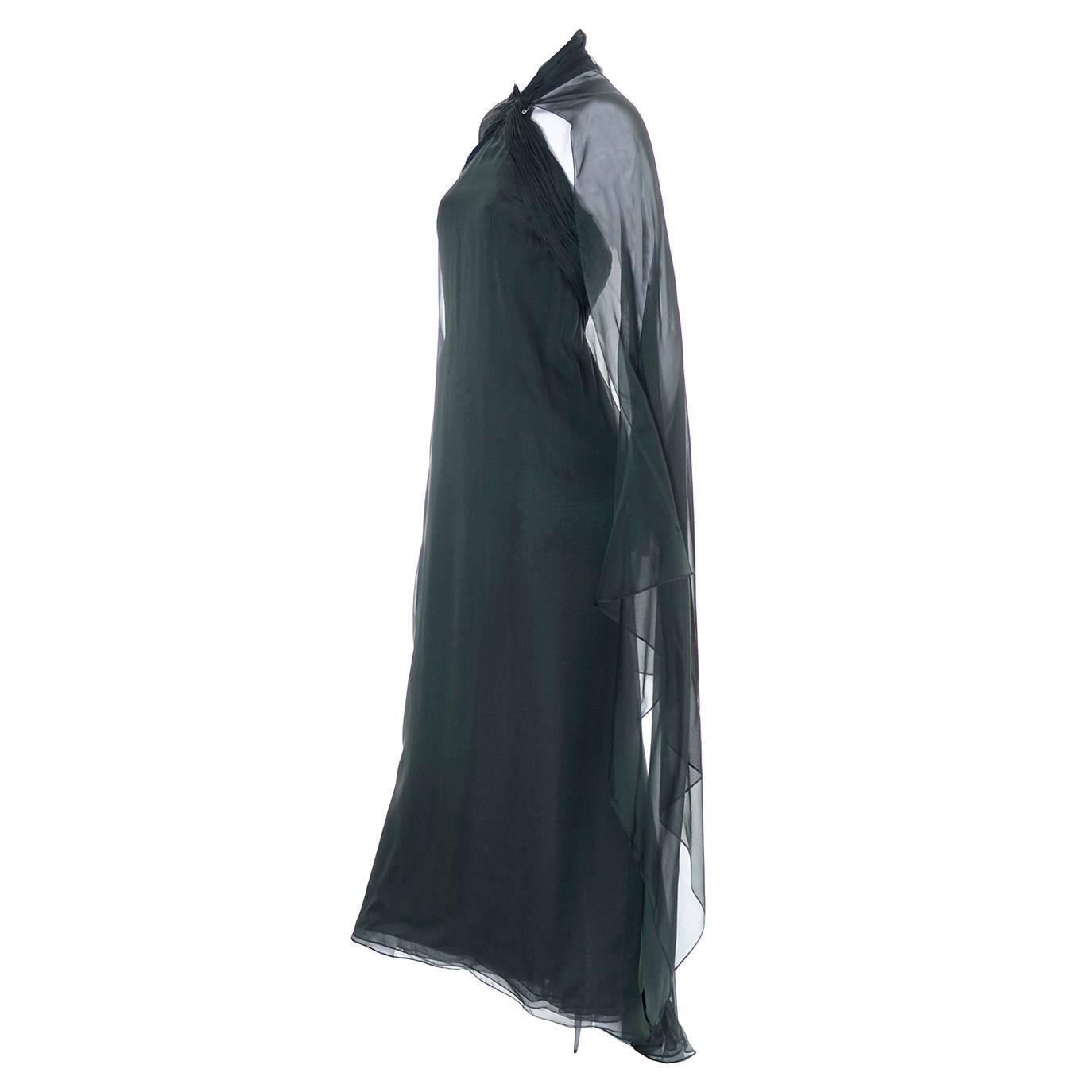 This beautiful vintage green silk dress was designed by Oscar de la Renta in the 1990's and was sold at Saks Fifth Avenue.  This deep green silk chiffon dress has an empire waist and an attached, flowing cape that can be worn as a cape or just left
