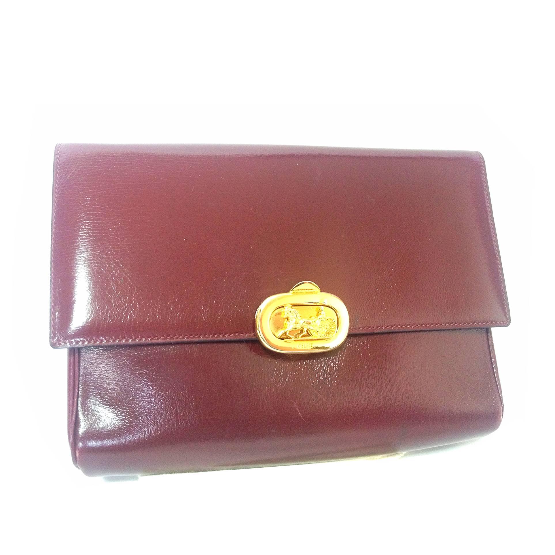 intage CELINE genuine wine brown leather clutch bag with golden carriage logo.