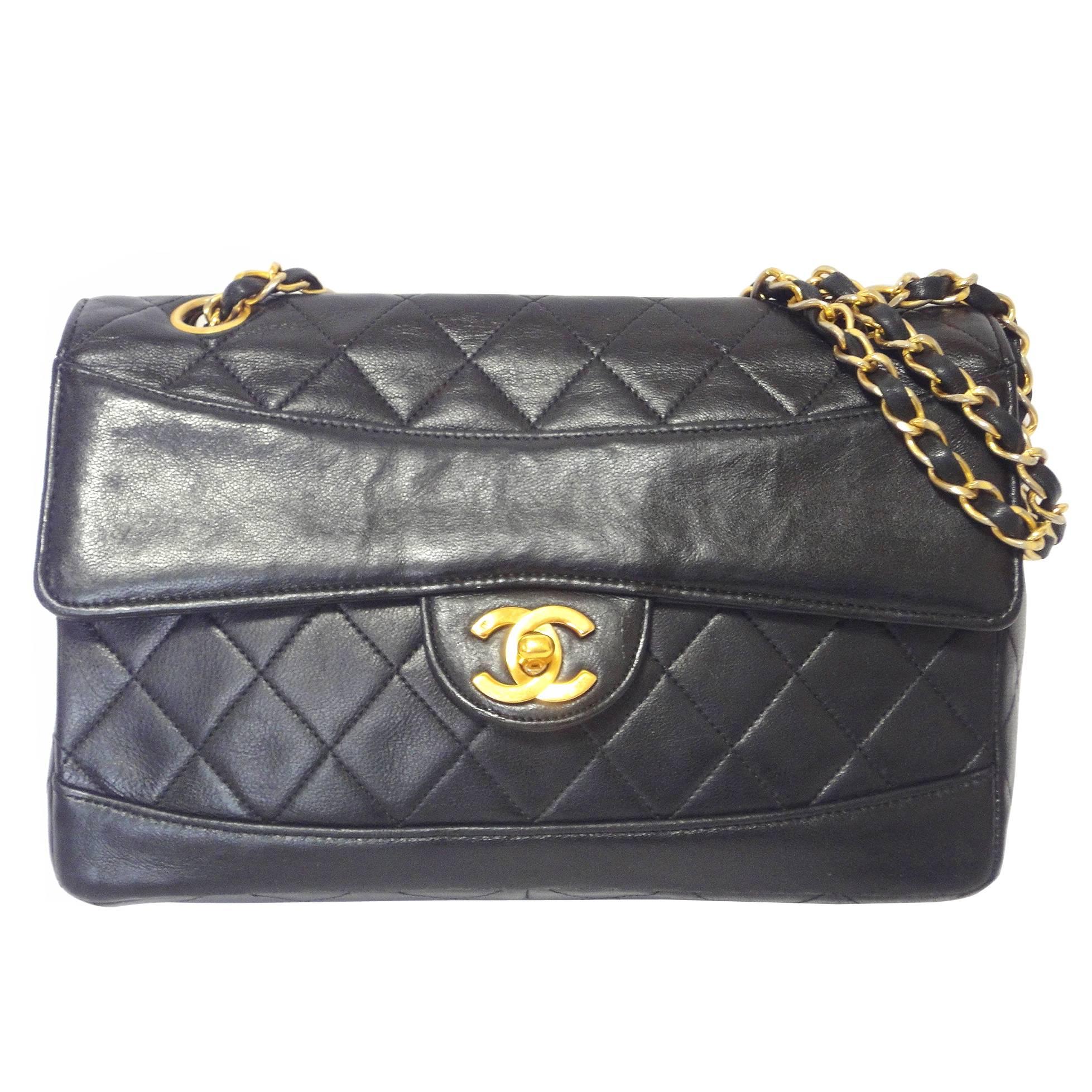 Vintage Chanel classic 2.55 black lambskin shoulder bag with golden chain straps