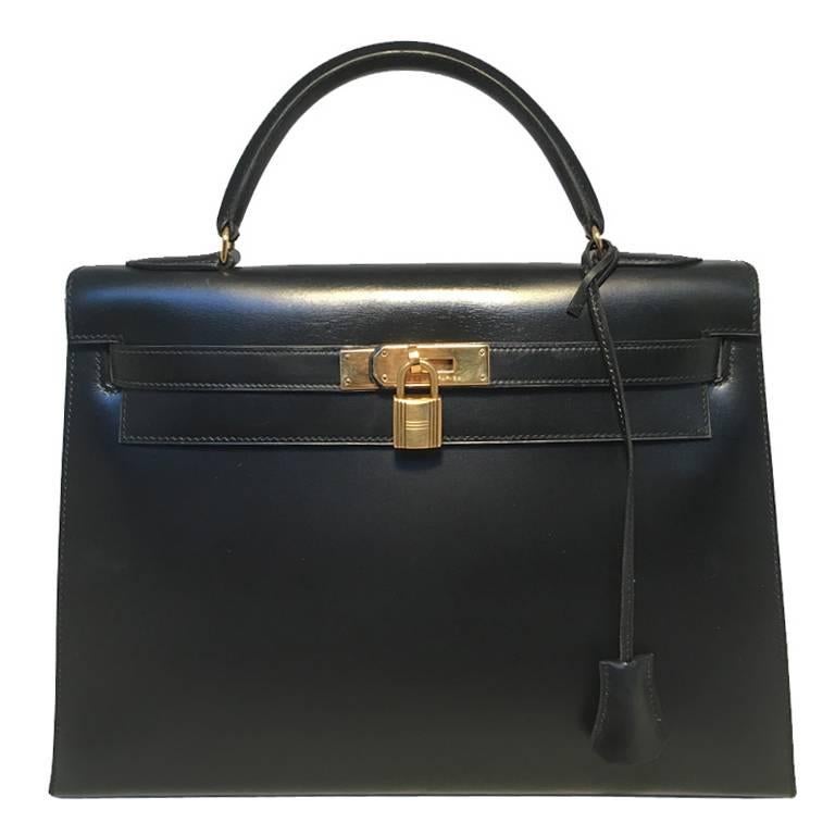 GORGEOUS Vintage Hermes 32cm kelly bag in very good condition.  Black box calf leather trimmed with gold hardware.  Front twist closure opens to a matching black leather lined interior that holds 2 slit and 1 zippered side pockets.  Stamped circled