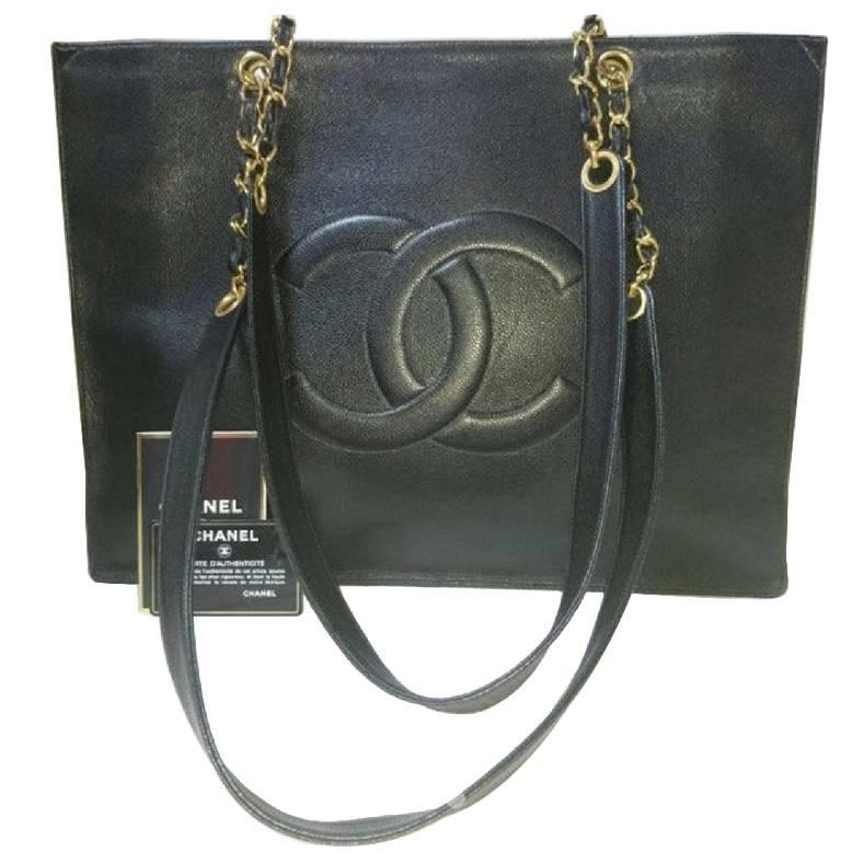 Vintage CHANEL black caviar extra large tote bag with gold tone chain straps. For Sale