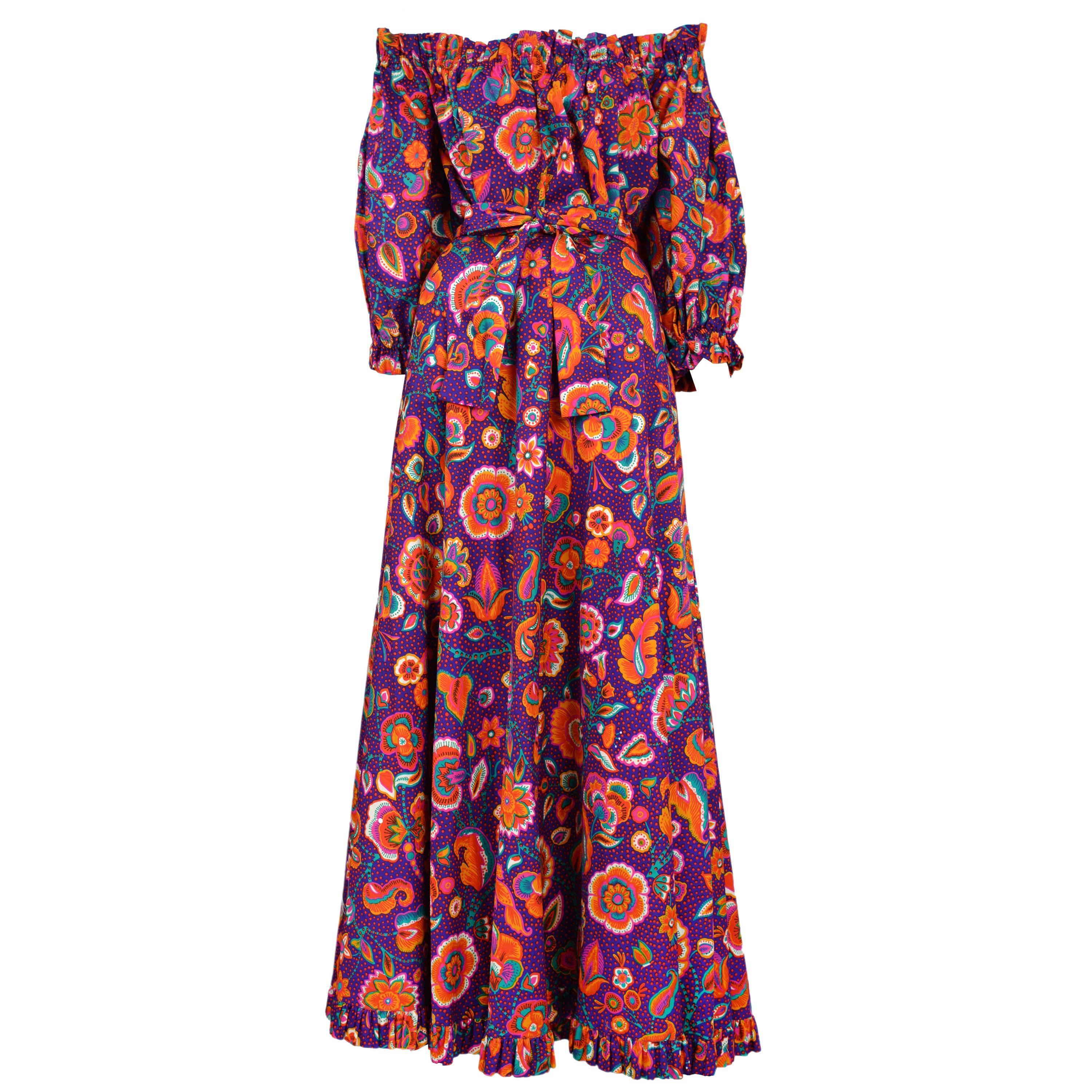 Vintage Yves Saint Laurent two piece ensemble featuring a gathered off the shoulder peasant blouse and a matching skirt with a ruffle flounce, both covered in a purple and red floral print.
Please inquire for additional images.