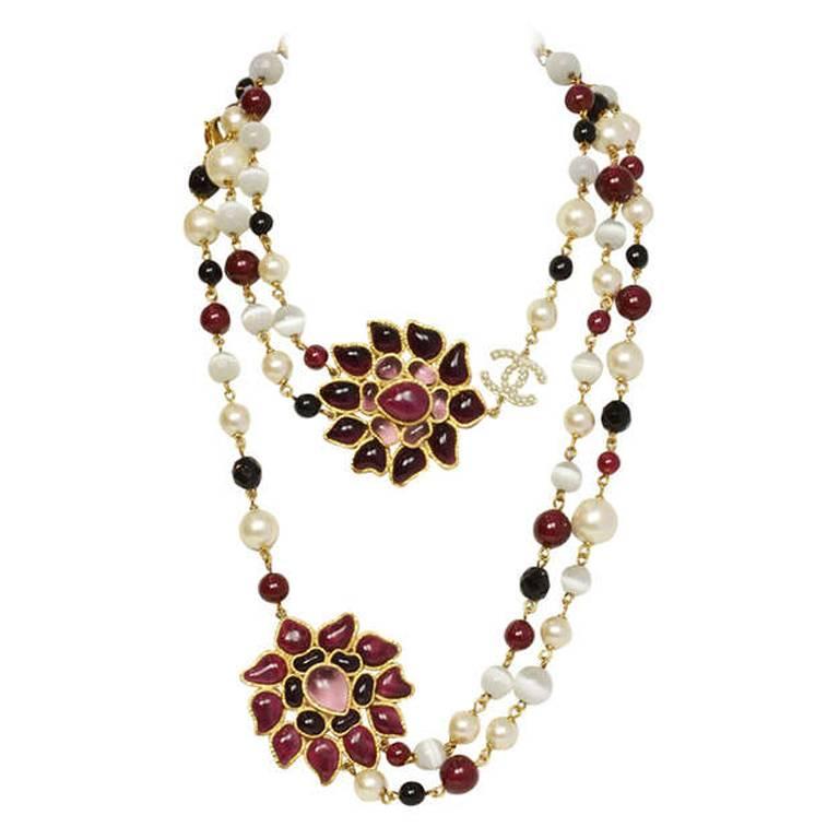 100% Authentic Chanel Long Beaded Necklace w/ Gripoix Medallions.  Features two poured glass pendants, faux pearls and black/burgundy/white resin beads.  Necklace is single strand until glass pendants where it separates into two strands.

Made In: