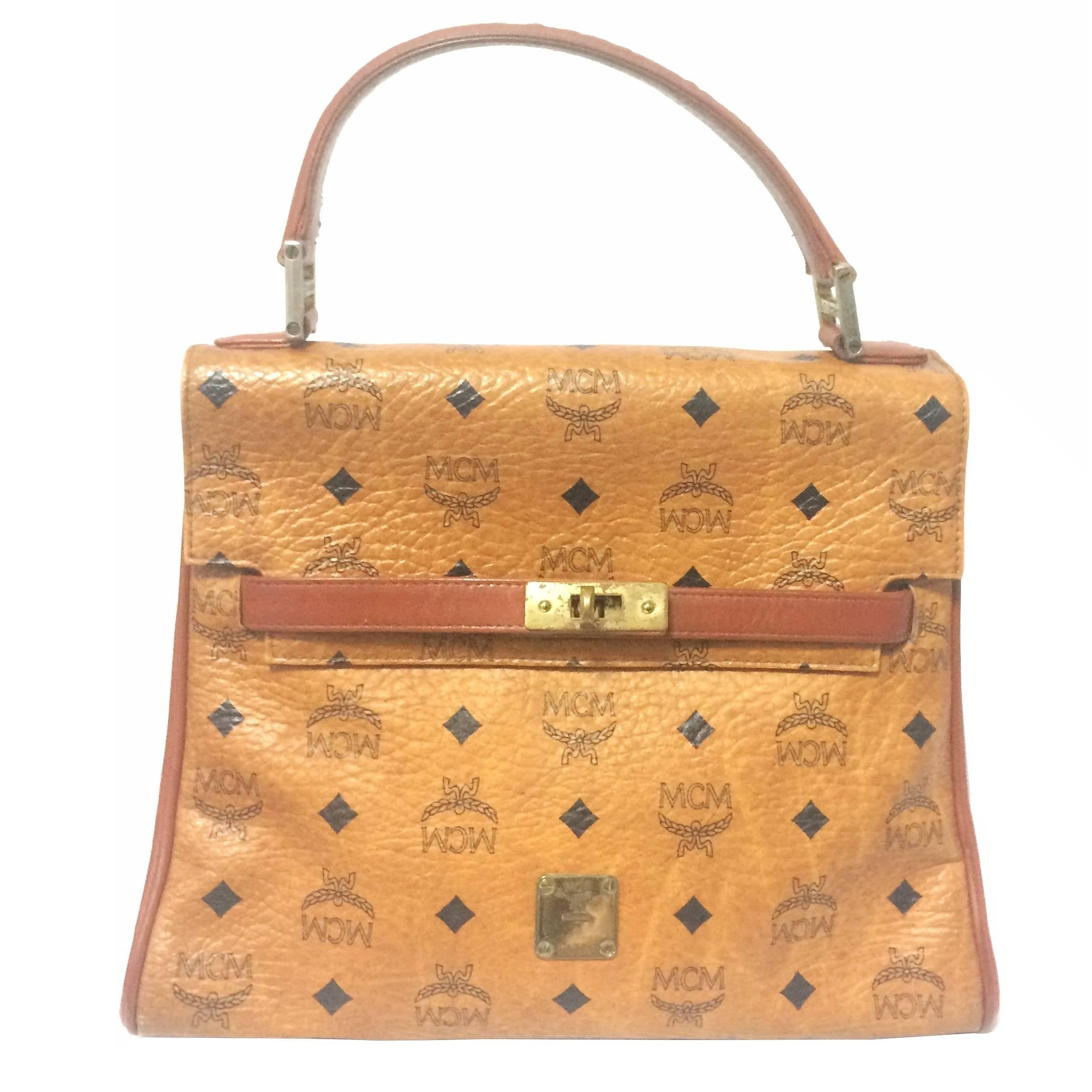 Vintage MCM Kelly style bag with golden logo plate in classic brown monogram.