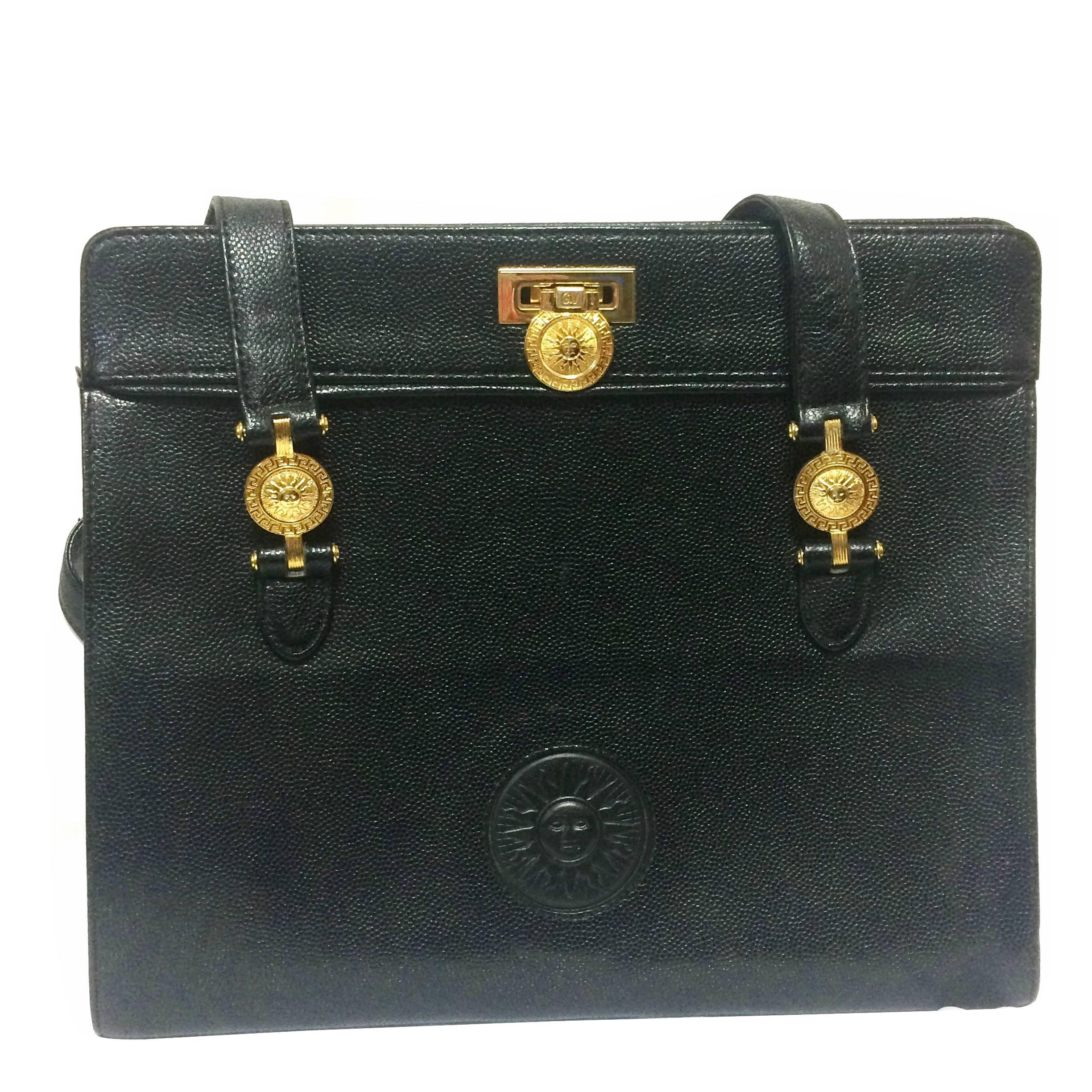 Vintage Gianni Versace black leather tote bag with golden sunburst motifs. For Sale