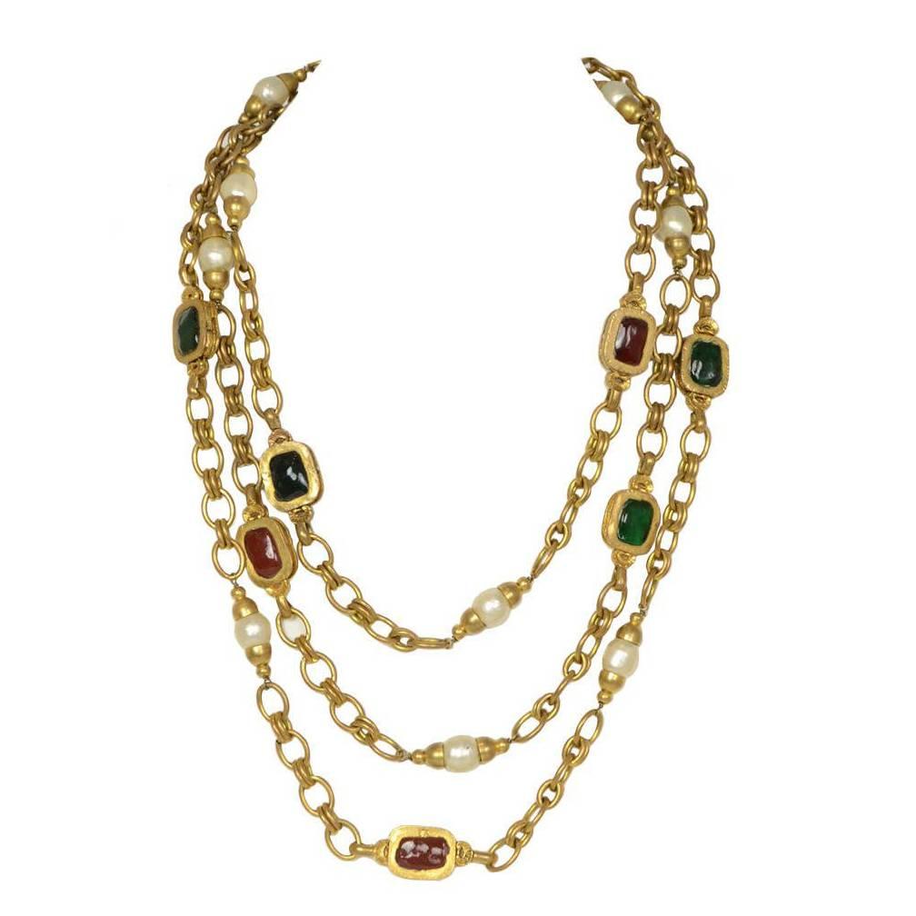 Chanel Chain Link & Gripoix Long Necklace 
Features faux pearl details throughout

Made In: France
Year of Production: 1984
Color: Goldtone, ivory, red and green
Materials: Metal, faux pearl and gripoix (poured glass)
Closure/Opening: Push