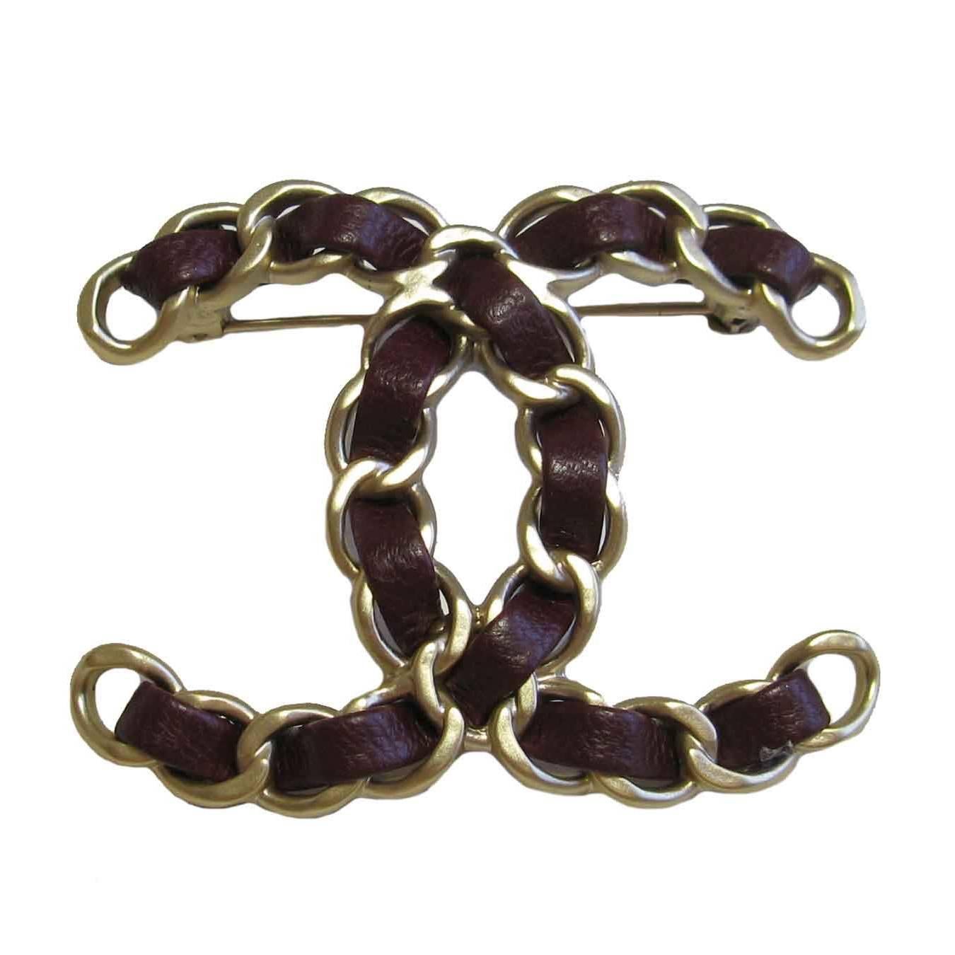 CHANEL CC Brooch in Gilt Metal Chain and Burgundy Leather at 1stDibs