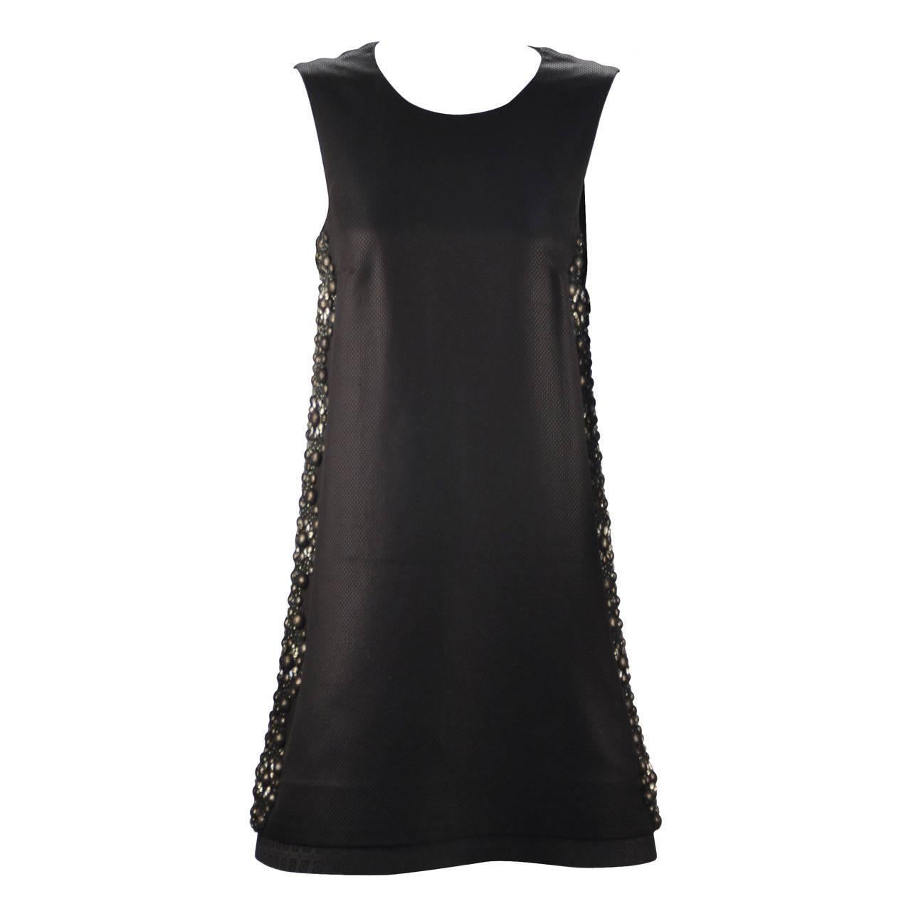 This A-Line black beauty is strikingly edgy - a Gucci masterpiece. The embellishments along the sides add glamour and interest. At the same time adding class and sophistication. Diamond crystals sparkle and round beads are covered with black tulle