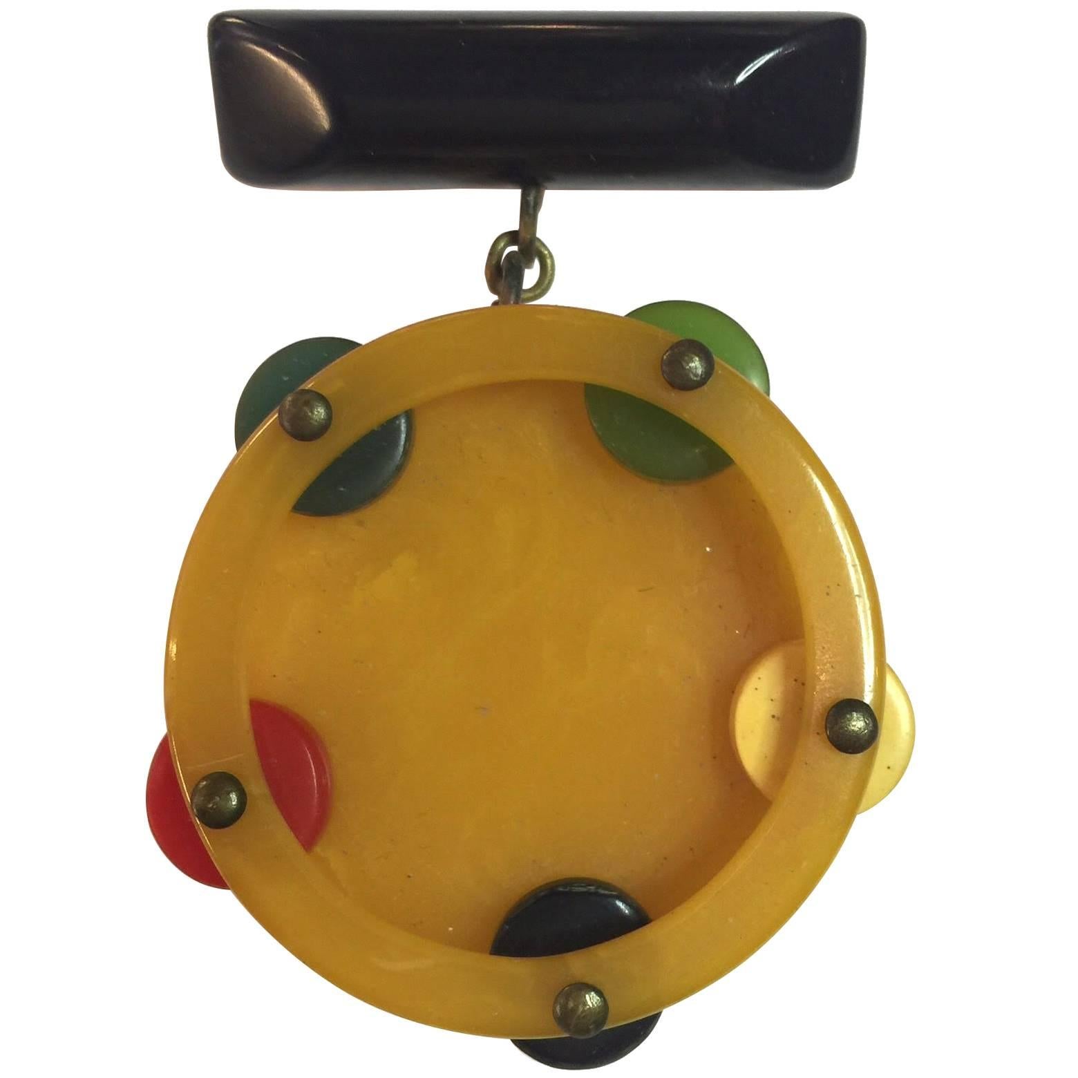 1930s Multicolored Bakelite Figural Tambourine Dangling from Bar Brooch Pin For Sale
