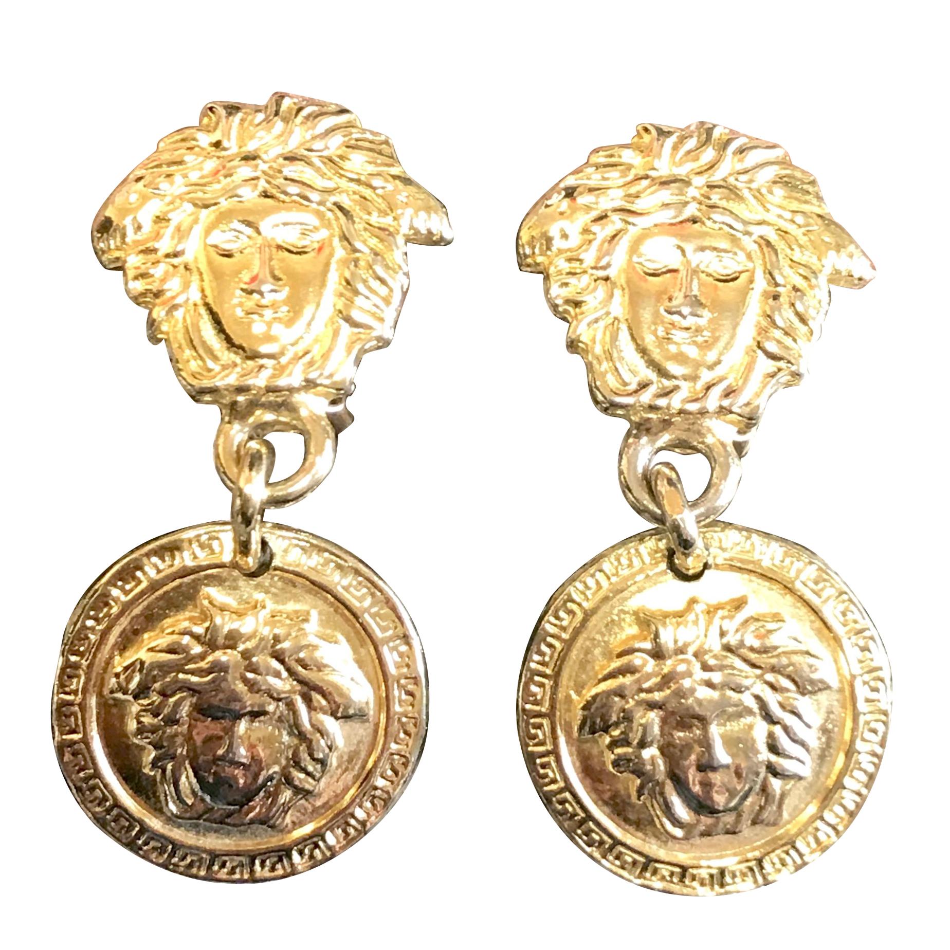 Vintage Gianni Versace gold tone medusa head, face motif dangle earrings.  For Sale