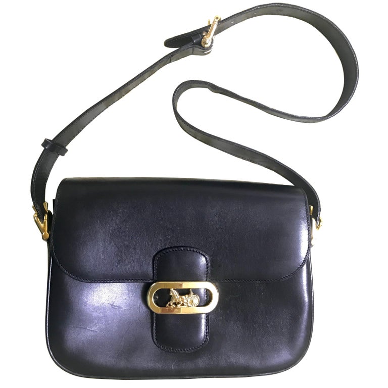 Vintage Celine black leather classic shoulder bag with golden logo closure. For Sale