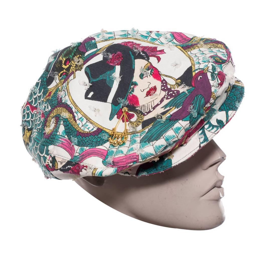 Christian Dior by John Galliano embellished printed canvas cap with gold-tone hardware.

Circumference 22”, Brim 2.5”

Fabric Content: 66% Cotton, 20% Acetate, 9% Polyester, 2% Elastane, 2% Lycra, 1% Resin
