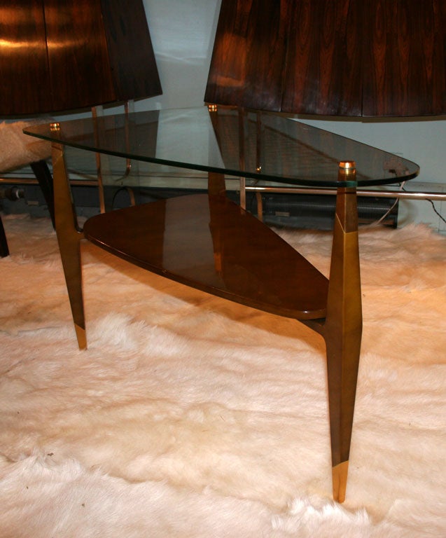 Spectacular table by Raphael from the same commission as the chest. Also finished in Beka lacquer this table as a spectacular design and details. The delicate top is actually a very resilient tempered glass. Signed on a brass plate to the bottom.
