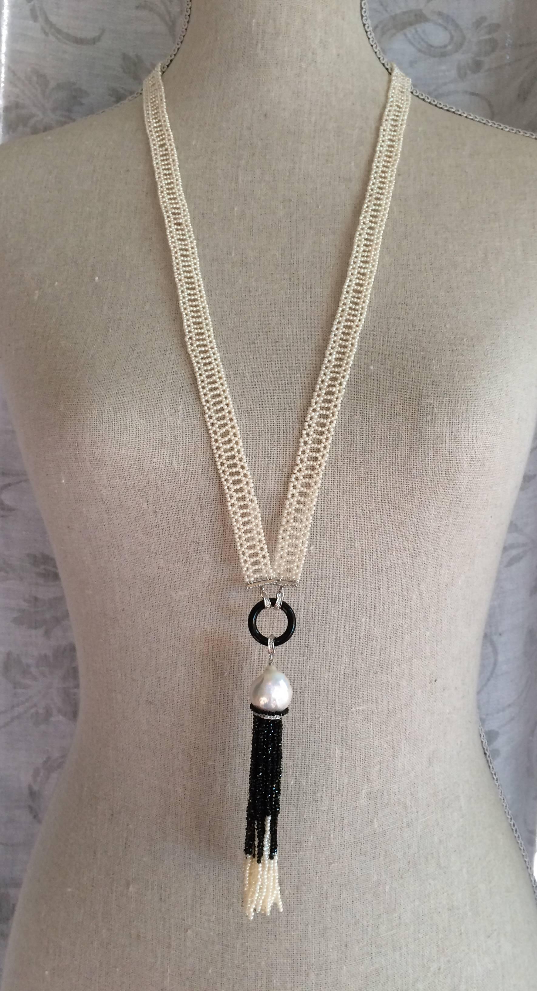 Seed pearl sautoir necklace. 33 inches long. The tassel is 5 inches long (removable). 

The seed pearls are 1mm, in an intricate pattern inspired by 19 Century sautoirs. Onyx circle, 14k white gold and diamond pieces, large pearl, black spinel