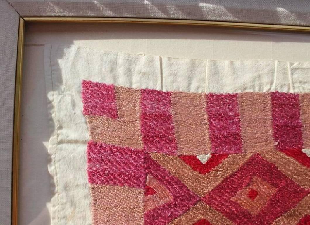 Large scale handwoven silk geometric tapestry or rug. Mainly red hues with diamond pattern. Framed in an Italian gold frame with a white matte.
Dimensions without frame: