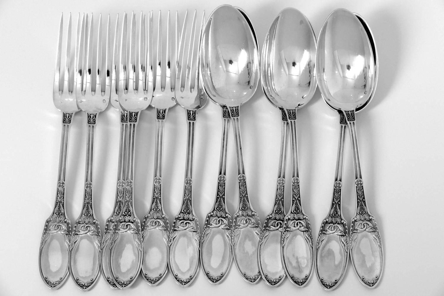 Combeau rare French sterling silver dinner flatware set 12 pc swans.

Exceptional French sterling silver dinner flatware 12 pieces Empire style, the spatulas are carved on both sides of interlaced swans. Beautiful palmette and laurel