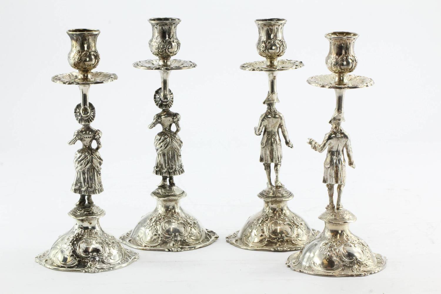 Set of four antique 800 silver Hanau Germany figural rococo candlesticks. They are in great antique estate condition and ready to use. They are each hallmarked 