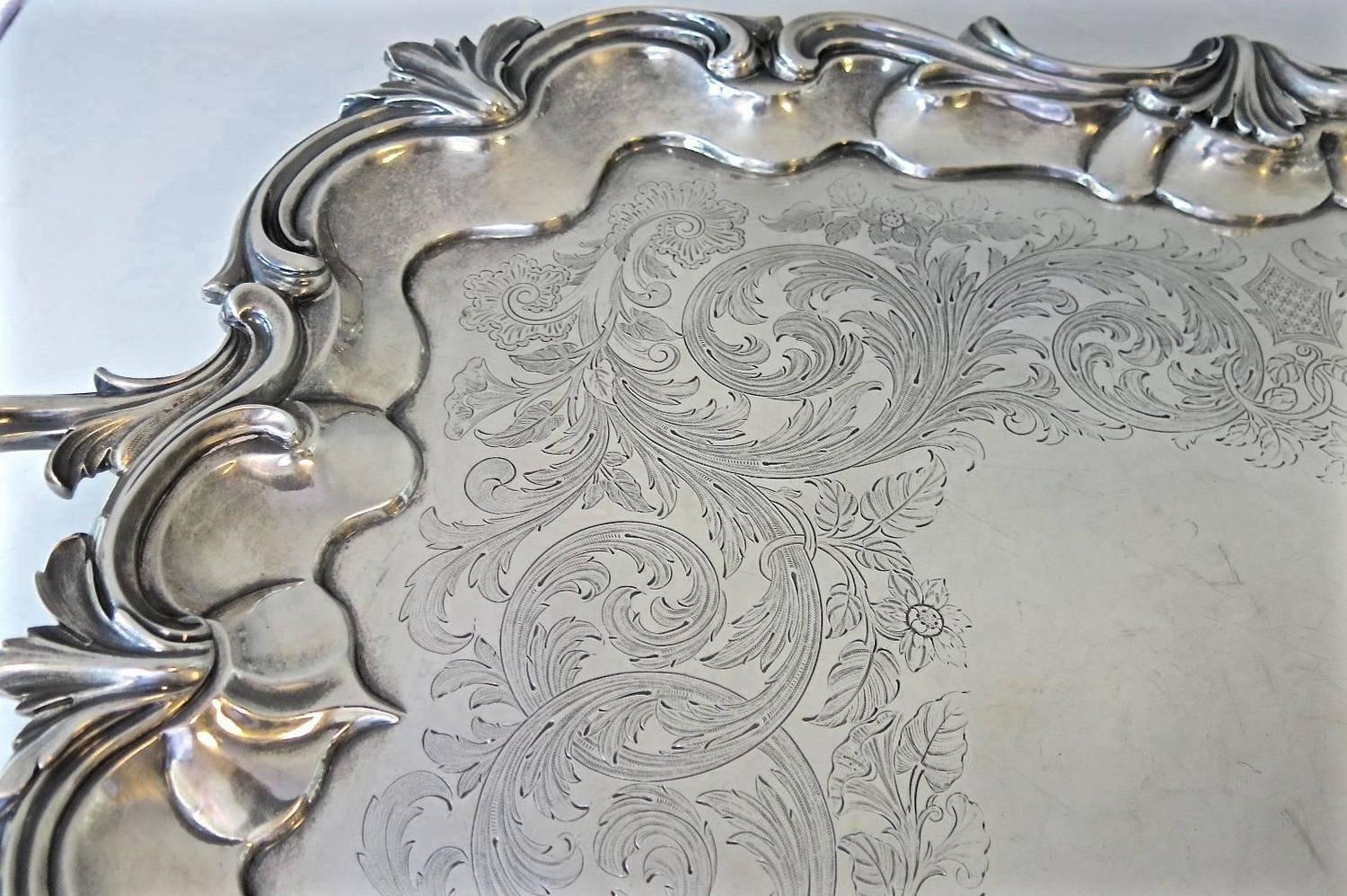 Superb quality, two-handled, antique Victorian sterling silver hallmarked tray. Beautiful hand engraved decoration, applied border, cast handles and standing on four cast shell feet. Measures: 30.25