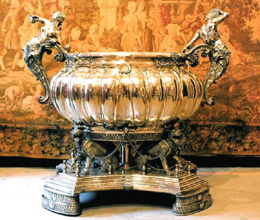 A monumental European sterling silver, massive wine cooler. 
Approximately 5,500 troy oz (170 Kilo) (375lbs).
54 inches (137cm) wide,
49 inches (124cm) tall,
36 inches (91cm) front to back.
After the original by C F Kandler, London 1735, that