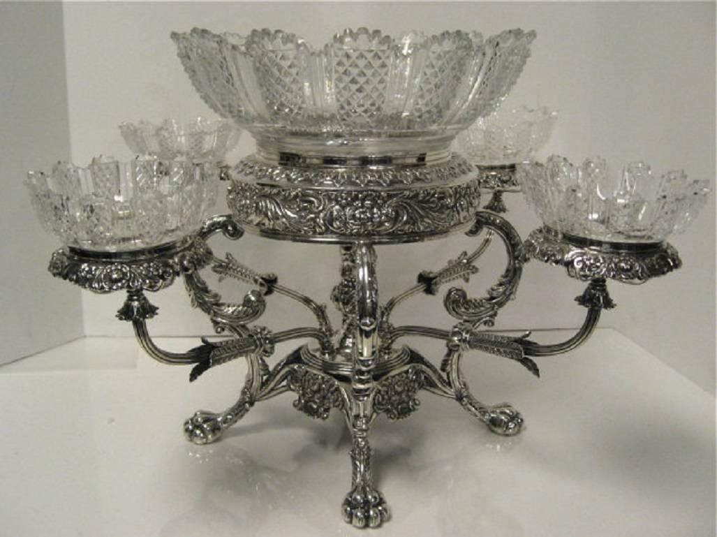 Antique English, George III, sterling silver four-arm epergne/centerpiece. Large center crystal bowl with four matching side bowls. Each arm is numbered and hallmarked and can be detached from the main frame of the epergne. Made By S.C Younge & Co.