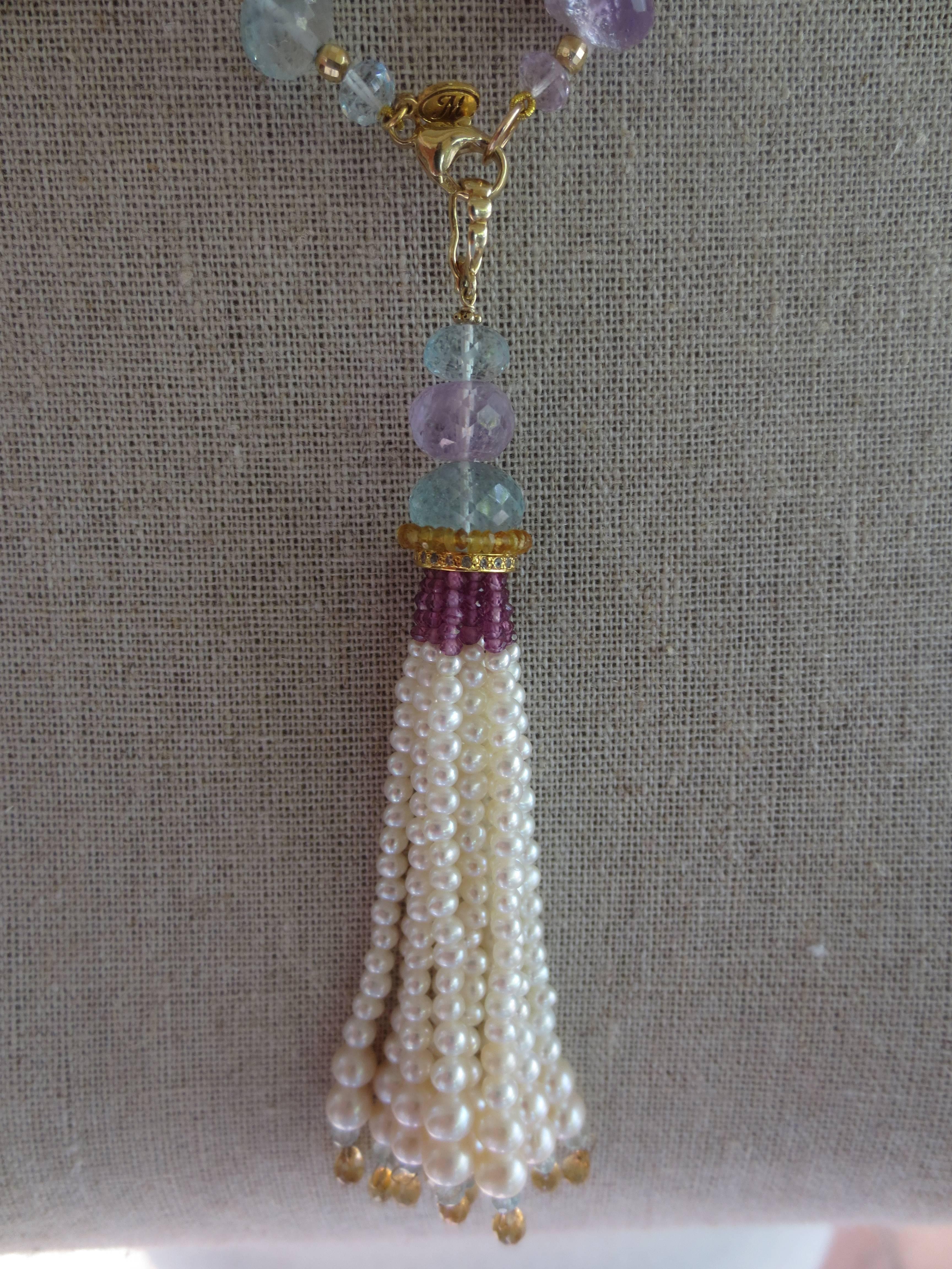 A 43 inch long sautoir by Marina J, with flat (coin) pearls, large fresh water pearls, aquamarines, citrines, amethysts, gold beads and gold findings. The tassel  is detachable and has a 14k yellow gold hook; it is 4 inches long, with graduated
