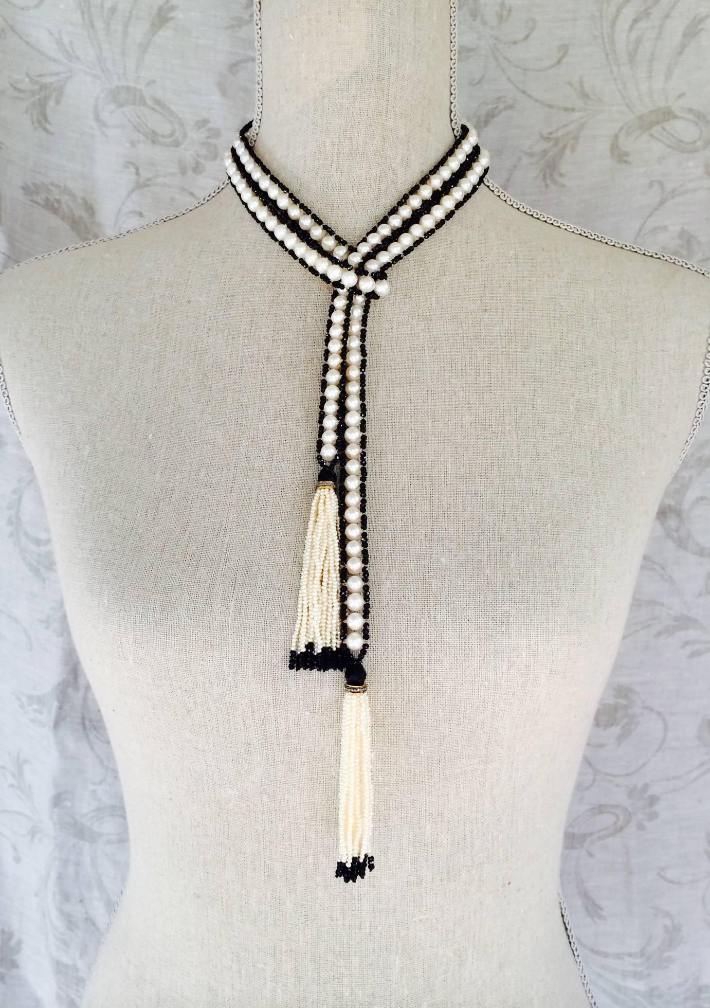 This decadent and lovely sautoir measures 52 inches with its tassels. Each of the tassels measures 3.1/4 inches long. 6 mm white pearls and 1mm faceted black spinel beads. 6mm black onyx faceted beads on top of each tassel and diamond, silver and