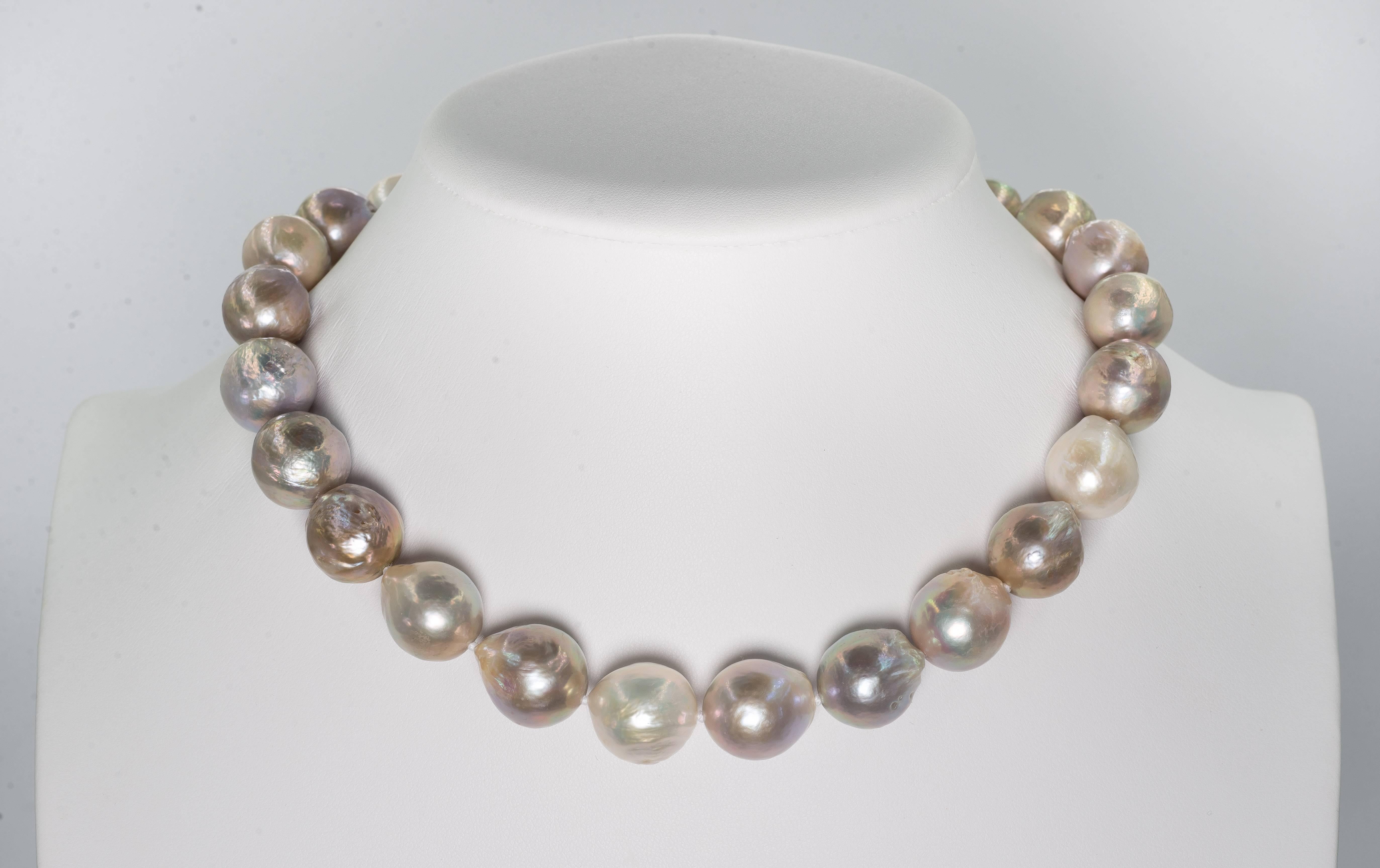 A wonderful high luster Silver Rosee Oyster cultured natural water slightly baroque large pearl necklace, slightly graduated 18mm to 16mm, most pearls on the larger size attached to a 14 karat gold invisible clasp. The necklace is 18 inches long.