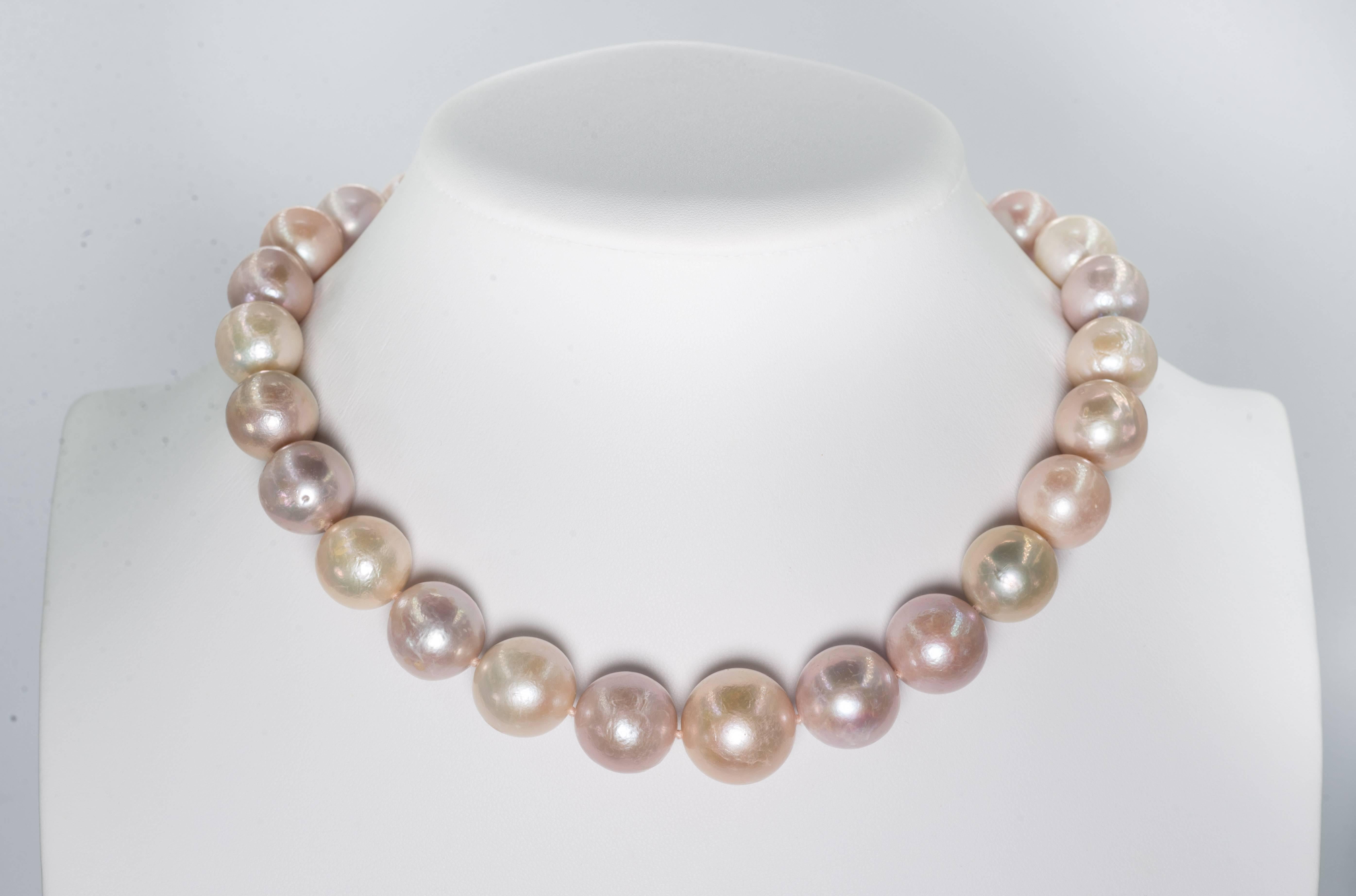 A wonderful high luster Argent Rose cultured natural water slightly baroque large pearl necklace slightly graduated, 16mm to 15mm, most pearls on the larger size, attached to a 14 karat gold invisible clasp. The necklace is 18 inches long.
