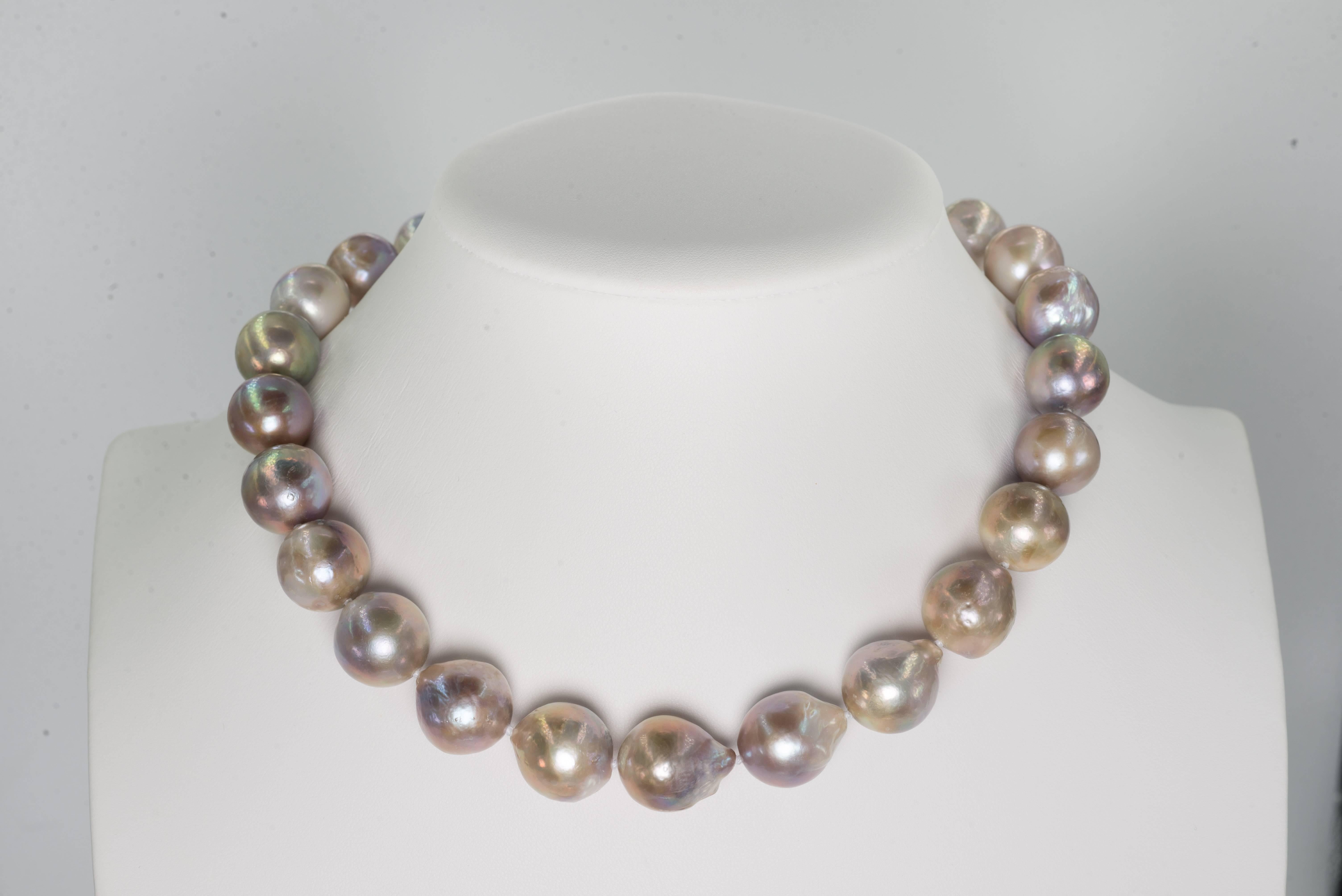 A wonderful high luster Rose Pompadour cultured natural water slightly baroque large pearl necklace, slightly graduated 18mm to 15mm, most pearls on the larger size attached to a 14 karat gold invisible clasp. The necklace is 18 inches long.

