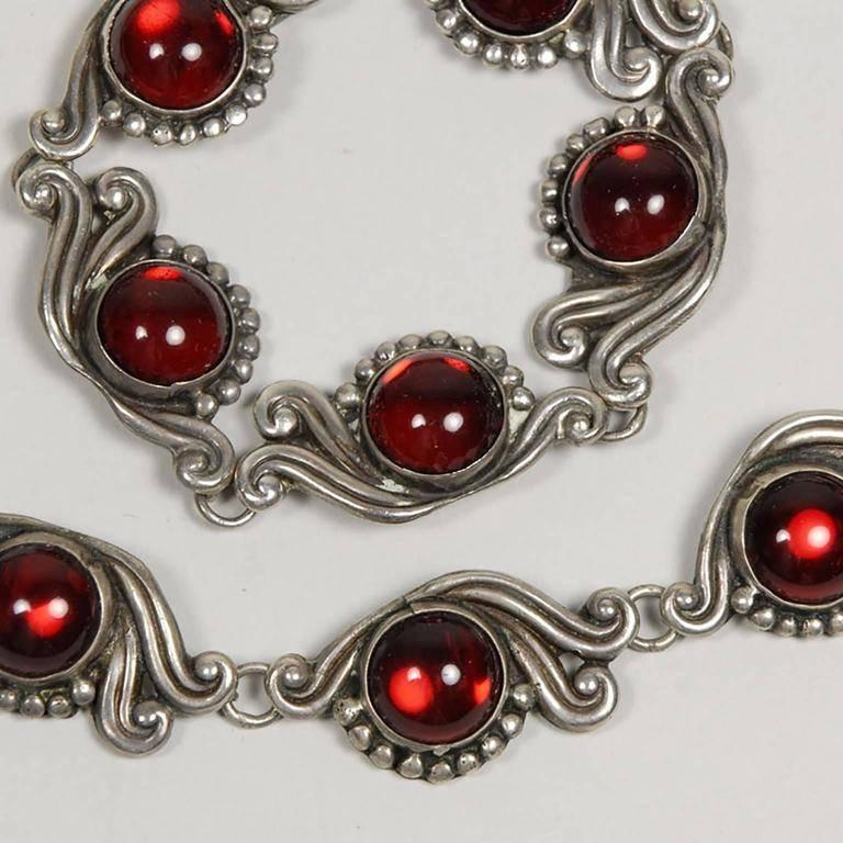 Mexican Taxco sterling silver and red glass necklace and bracelet, by Gerardo Lopez, mid-20th cetury; stamped "Lopez Taxco";
Length of necklace: 14 inches.
