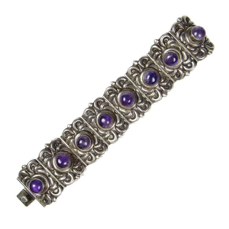 Horacio de la Parra Mexican silver and amethyst bracelet, circa 1940; comprised of eight cabochon amethysts in an ornate foliate sterling silver setting, marked "Sterling/Mexico: with "PA/RRA" in center.
Measures: Length: 6 3/4