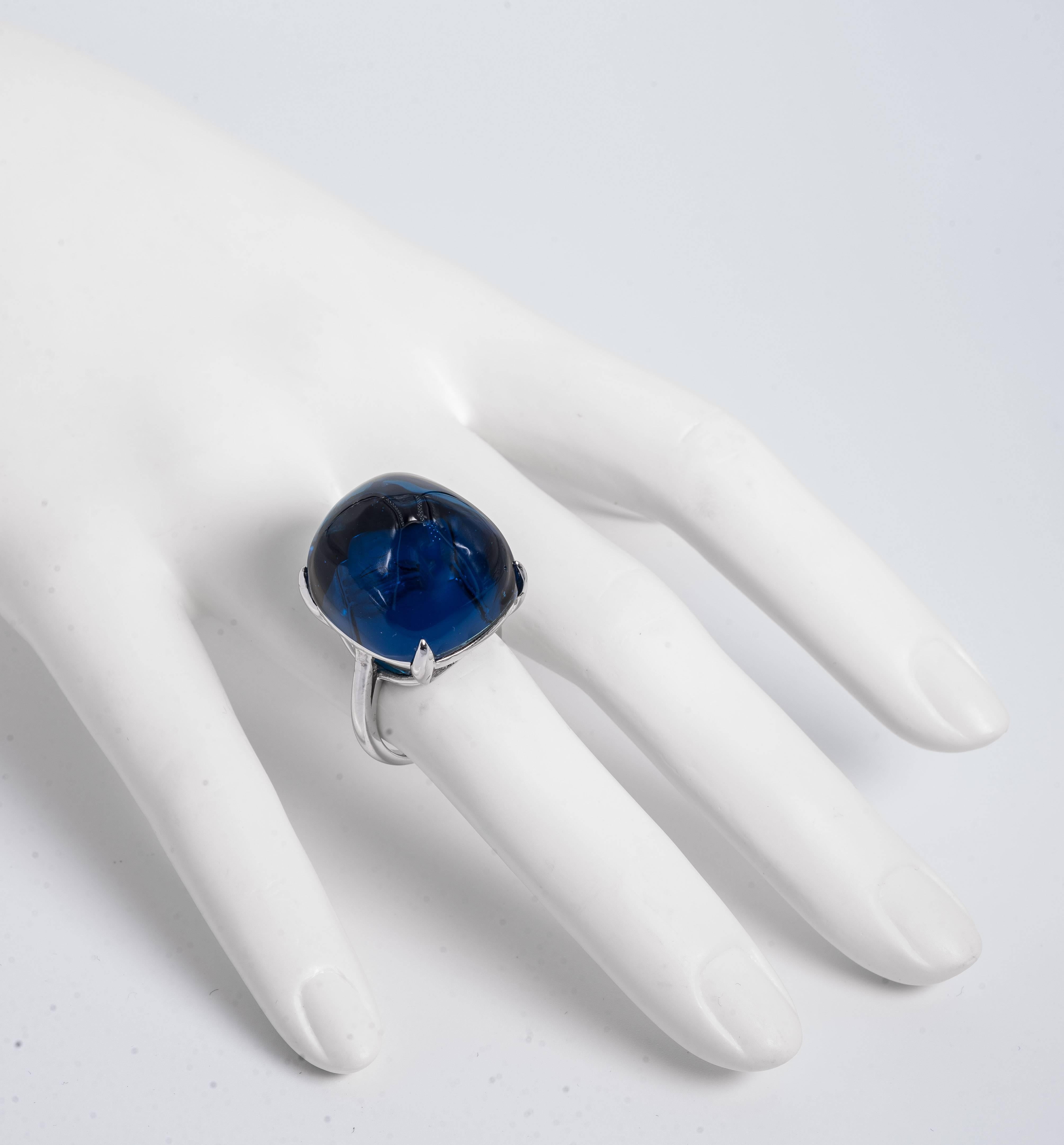 For chic simplicity. A fabulous large domed faux blue sapphire cabochon sterling cocktail ring. Faux man made sapphire measures around 3/4inch. Complimentary sizing. Please state size with your order.
